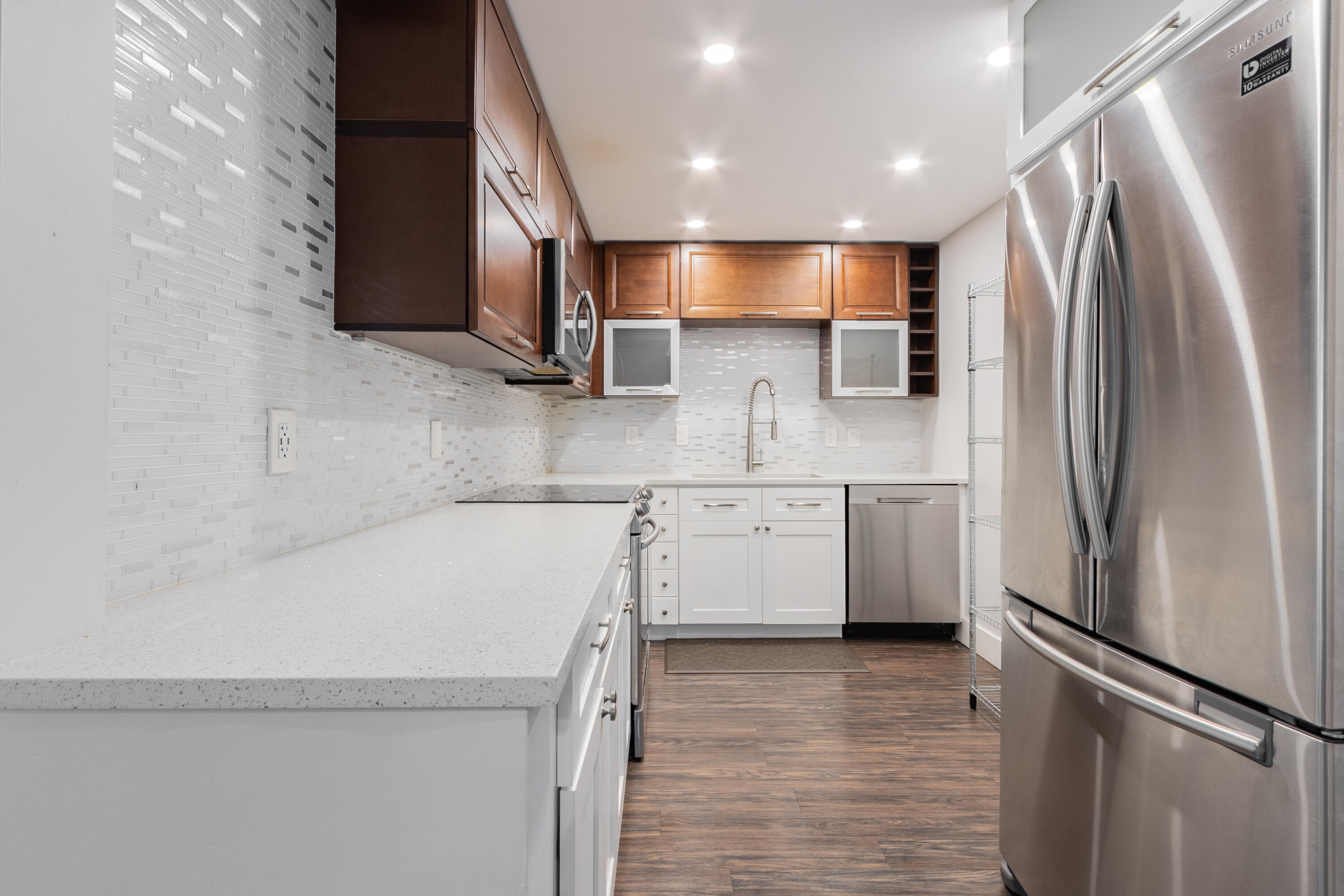 Beautifully renovated condo in the prestigious Omega community. Bright, open floor plan with fresh paint, LED recessed lighting, and custom fans throughout. Stylish eat-in kitchen with quartz countertops, tile backsplash, wood cabinetry, and stainless steel appliances. Spacious primary bedroom with two large closets and private en-suite. Enjoy a covered private balcony overlooking lush landscaping. Just a short walk to the pool, with access to a clubhouse, tennis courts, and laundry on the same floor. Assigned and guest parking included. Prime location near top-rated schools, parks, dining, shopping, and the Turnpike. A/C 2005. 50-year recertification complete. No leasing first two years.