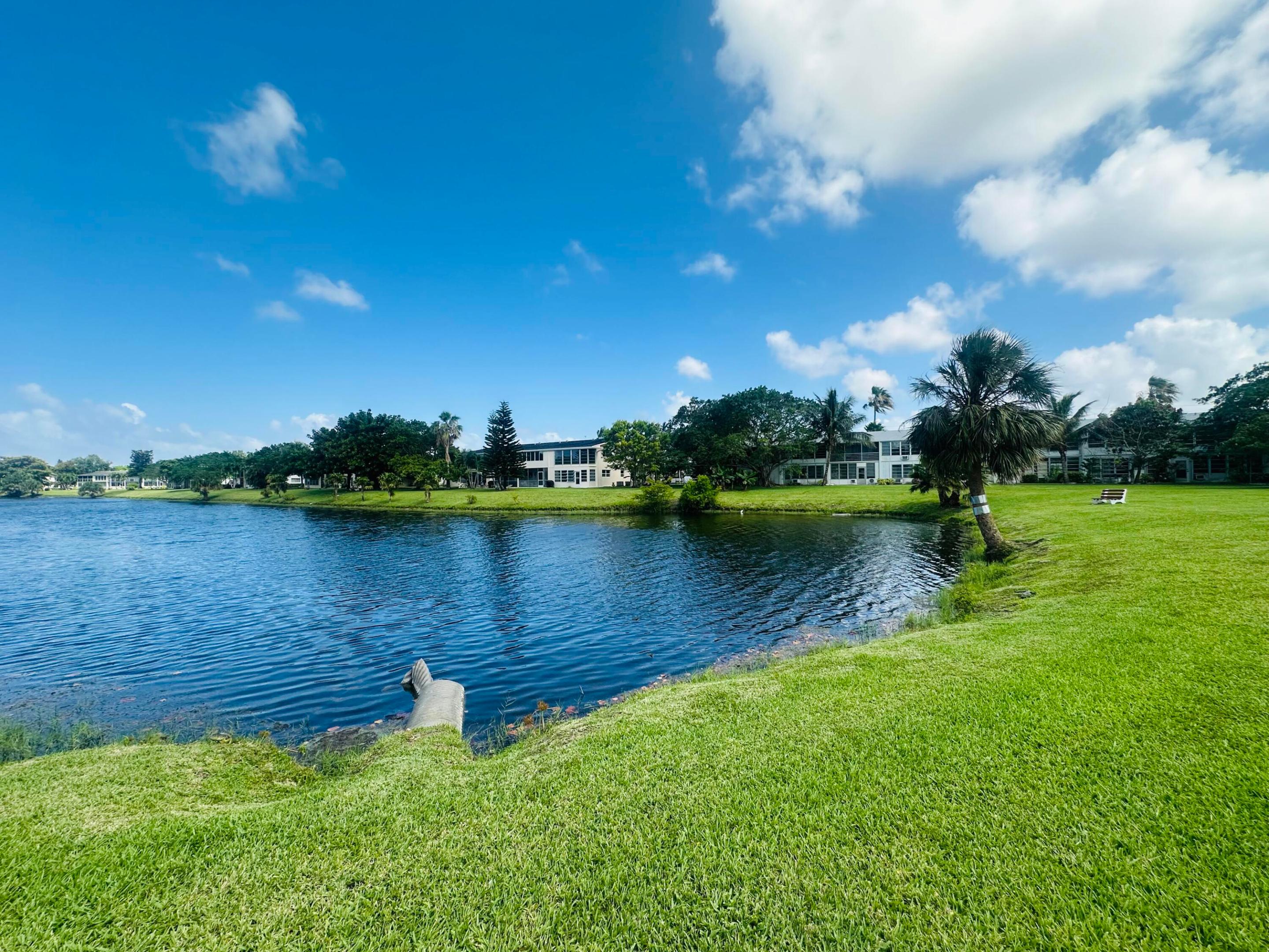 Beautifully remodeled 2BR/1.5BA 1st flr condo w/SERENE CANAL VIEW & desirable East exposure. Updated kit features granite cntrs, tile backsplash, recessed leg, white appl & extended cabs. Lam flrs in liv areas & tile flrs in bdrm. Sold fully furnished w/3 TVs & 7 ceiling fans. Updated baths w/granite cntrs,; primary bath features a glass-encl shower. Encl patio w/plexiglass windows, roll-down shutters, storage closet, & exterior access door. Lg. brick patio overlooking the water, perfect for enjoying BEAUTIFUL SUNRISES! Conveniently located near Westgate & within walking dist to pool, tennis, pickleball & rec center. Move-in ready! Active, adult community w/pools, tennis, pickleball, putting green & a magnificent clubhouse w/tons of amenities! ASSOC. CLAIMS 55+