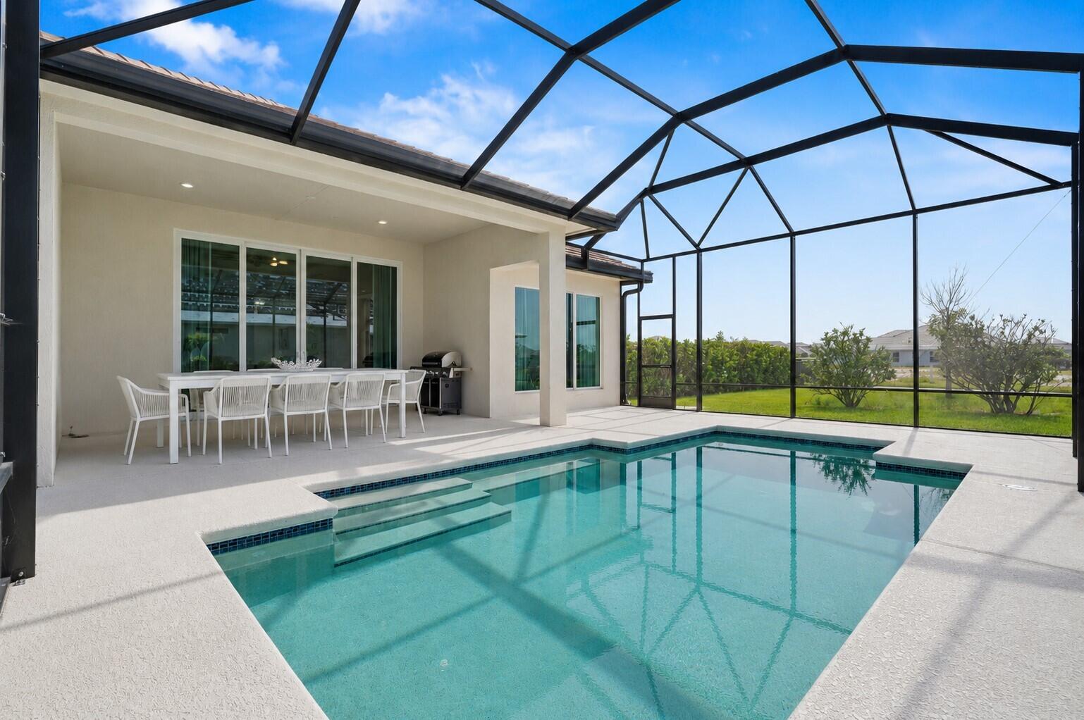 Welcome to Traditions Boutique luxury community built by GHO homes. A total of just 300 homes once complete. Why wait to build when you can buy this Iris for a great return on your investment?! 3 beds, 3 baths, 3 car garage. Chic salt pool fully screened in overlooking the lake with plenty of space for tanning. Enjoy indoor/outdoor living with 10ft impact sliders off the living room to the pool area. Amazing entertaining space.  Enjoy a gas cooktop with a stainless range hood, built in wall oven, quartz countertops and a dreamy cabinet color that's not your boring white. Primary bath features dual walk-in closets, a separate water closet & dual shower heads in an expansive walk-in shower. Oversized wood plank tile throughout. 8ft solid core wood interior doors throughout. 71/4in baseboards & crown molding. 3-car garage with Electric vehicle charging station & epoxy floors. All impact glass windows/doors. Gas water heater. HOA includes lawncare, cable, internet, gated entry, security system, irrigation & common areas. Common areas include the clubhouse, pool, fitness center, tennis, pickleball, basketball, game room, kitchen, secured gated entrance and more.