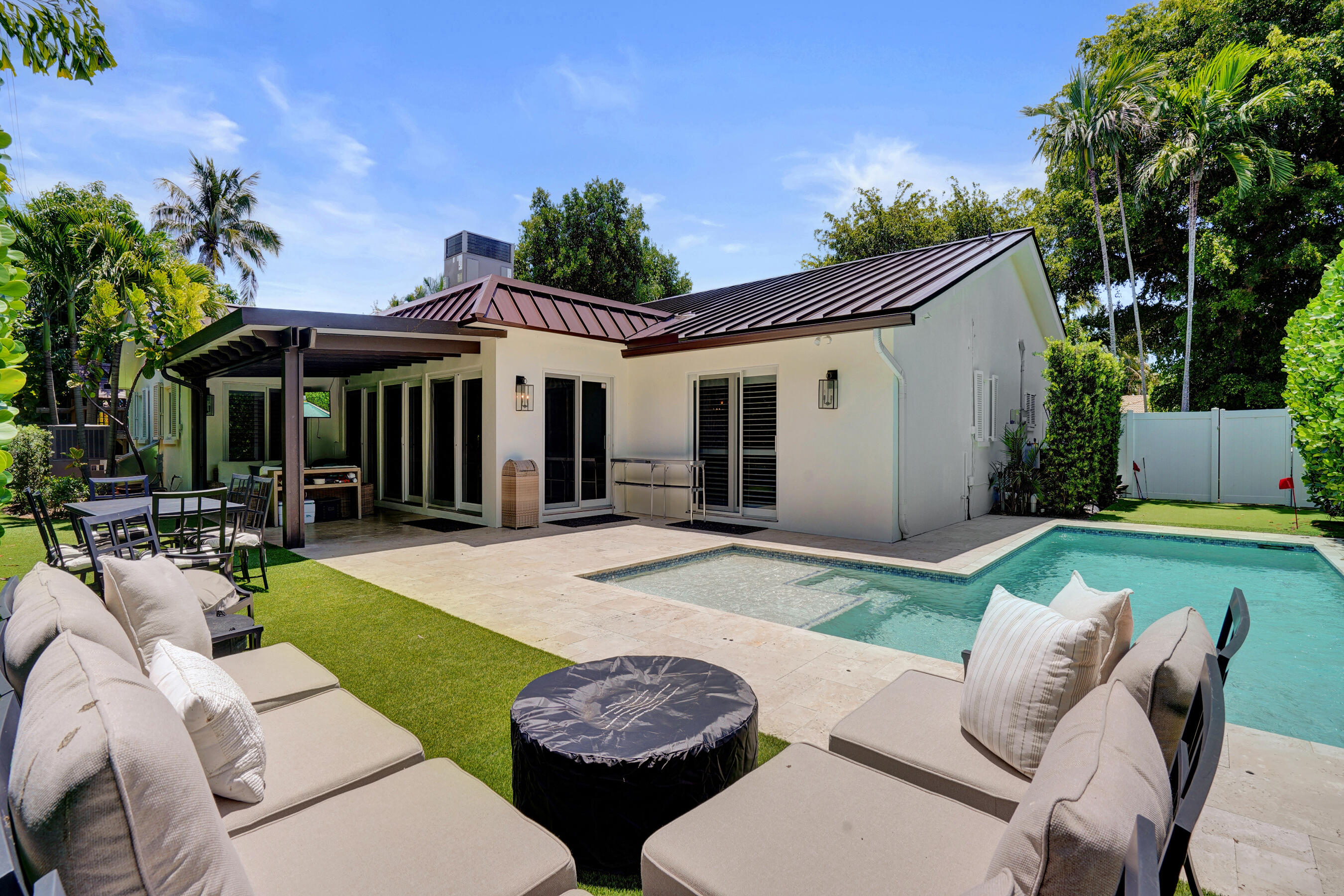 Nestled just moments from Coral Ridge Country Club, this beautifully updated residence offers the perfect blend of comfort, privacy, and South Florida living. This home is equally ideal for anyone seeking a private retreat in one of Fort Lauderdale's most desirable neighborhoods.  Step outside to your own backyard oasis featuring a resort-style pool, lush turf, putting green, sauna, and inviting outdoor living spaces designed for year-round enjoyment. Whether you're entertaining guests, catching the game on the outdoor TV, or enjoying a peaceful evening under the stars, this home truly has it all.