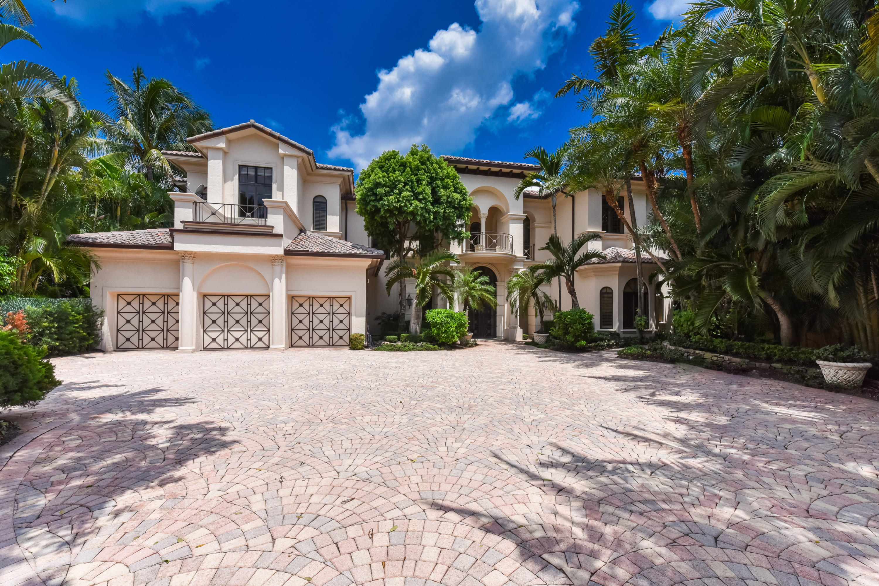 $780,000 PRICE REDUCTION!! BRING OFFERS!! Magnificent gated estate on the most private, exclusive street in Boca Raton located on the grounds of the prestigious Boca Raton Resort & Club Waldorf Astoria. Situated on a ½ acre pie shaped cul-de-sac home site with sweeping views of the magnificent lakes & fairways of the resort. This lake front two-story gated estate is comprised of 5 BR, 7 ½ BA plus exercise room & office. Enter this grand estate through double impact glass doors into the impressive foyer with Murano glass chandelier & floor to ceiling windows with natural sunlight streaming through from the private courtyard. Open floor plan with views of the infinity edge pool, lake & fairways from living room, family room, kitchen & sun drenched impact glass atrium-like Florida room. Magnificent gated estate on the most private, exclusive street in Boca Raton located on the grounds of the prestigious Boca Raton Resort & Club Waldorf Astoria. Situated on a ½ acre pie shaped cul-de-sac home site with sweeping views of the magnificent lakes & fairways of the resort. This lake front two-story gated estate is comprised of 5 bedrooms, 7 ½ baths plus exercise room & office. Enter this grand estate through double impact glass doors into the impressive foyer with Murano glass chandelier & floor to ceiling windows with natural sunlight streaming through from the private courtyard. Open floor plan with views of the infinity edge pool, lake & fairways from living room, family room, kitchen & sun drenched impact glass atrium-like Florida room.

Large gourmet chef's kitchen with oversized center island is complete with state-of-the-art appliances including two Dacor wall ovens, six burner Dacor gas cook top, two warming drawers, two Dacor dishwashers & side by side Sub-Zero refrigerator/freezer. Large Costco pantry off kitchen & butler's pantry featuring Sub-Zero wine cooler, two refrigerated drawers & hidden access into the dining room. The opulent upstairs master suite includes French doors that lead into a glass enclosed exercise room & balcony overlooking the fabulous pool/patio area as well as the lakes & fairways of the spectacular resort. The master suite also features separate his & her baths with elegant appointments & fixtures & each with king & queen sized custom fitted closets. The second level of this estate also features two queen suites each with morning bars & balconies overlooking the lush grounds. The tropical patio area features an infinity edge heated pool & raised spa, summer kitchen, multiple covered loggias & sitting areas, including a beautiful trellis on the water's edge. Other features of this stunning estate include attached guest quarters with bedroom, family room, bathroom & kitchen, impact windows throughout, elevator, generator, 4-car garage with oversized motor court which will easily accommodate visiting friends and family, a gated front entry & mud room/laundry room with large pantry. Some photos are virtually staged.