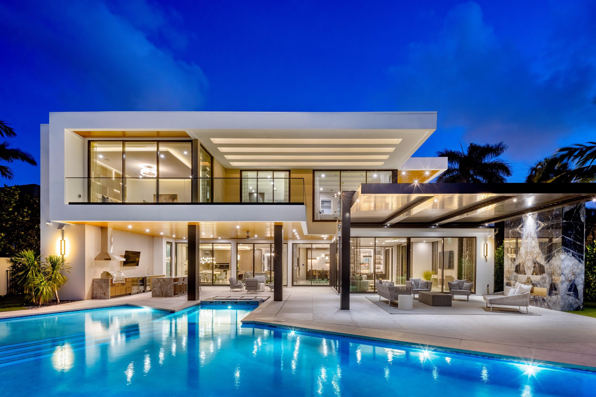 Located at 217 Thatch Palm Drive within the prestigious Royal Palm Yacht & Country Club, Villa Valmont is a newly completed contemporary 6 bedroom/9 bathroom estate positioned along the 15th fairway of the acclaimed Jack Nicklaus Signature Golf Course, offering an extraordinary blend of architecture, craftsmanship, and resort-inspired living. Offered fully furnished and meticulously curated throughout, the residence delivers a truly turnkey ownership experience. Encompassing more than 12,334 total square feet, the residence is the result of an exceptional collaboration between renowned builder Albanese & Sons, BE Design Associates, and Zelman Style Interiors, creating one of the most compelling newly completed offerings within Boca Raton's premier country club community. From sunrise over the fairways to evenings illuminated by the glow of the resort-style grounds, Villa Valmont captures the essence of luxury golf course living at its finest.   Upon arrival, dramatic architectural lighting defines the entry experience, complemented by lush, professionally designed landscaping that enhances privacy while maintaining a refined and polished aesthetic. A tranquil waterfall feature sets the tone for the residence beyond. A striking two-story foyer introduces the home's exceptional design, where bespoke millwork, the finest materials, and curated finishes create an atmosphere of timeless sophistication.   Grand entertaining spaces flow seamlessly throughout the residence, anchored by an expansive great room featuring a custom marble fireplace and a glass-enclosed wine display. Floor-to-ceiling glass walls frame sweeping golf course views while bathing the interiors in natural light, creating an ever-changing backdrop from sunrise to sunset. Designed for both grand-scale entertaining and intimate daily living, the home offers a thoughtfully curated collection of formal and informal gathering spaces. The chef's kitchen is both functional and exquisite, appointed with premium Miele appliances, custom cabinetry, and a fully equipped butler's pantry. A sophisticated club room with a full-service bar and a retractable glass-walled executive office further enhance the home's exceptional lifestyle and entertaining appeal.   The primary suite rivals a luxury resort retreat, overlooking the resort-style pool and fairway beyond. This private sanctuary features dual spa-inspired bathrooms, expansive custom wardrobes, a morning bar, and a private terrace designed for quiet relaxation. Additional accommodations include generously appointed guest suites, an upstairs lounge, and a discreet fitness room complete with a private sauna and full bathroom.   Designed to embrace South Florida's coveted indoor-outdoor lifestyle, the resort-inspired grounds feature a custom pool and spa, multiple fire features, expansive entertaining terraces, and a summer kitchen. A dramatic motorized-louver pergola creates an outdoor living room centered around a fireplace, offering the perfect setting for year-round entertaining or relaxed evenings overlooking the fairway. Professionally designed landscaping emphasizes privacy while preserving open golf course vistas and a tranquil estate-like atmosphere.   Additional features include a four-car garage with a dedicated golf cart bay, private elevator, Control4 smart home automation, full-house generator, and a fully integrated audio-visual and home technology system designed for seamless modern living.   Situated within the gates of Royal Palm Yacht & Country Club, residents enjoy one of South Florida's most coveted lifestyles, moments from the Atlantic Ocean, Mizner Park, The Boca Raton, championship golf, world-class yachting, luxury shopping, fine dining, and convenient access to both Palm Beach and Fort Lauderdale international airports. This is a rare opportunity to own a newly completed estate that exemplifies the very best of luxury living in Boca Raton.