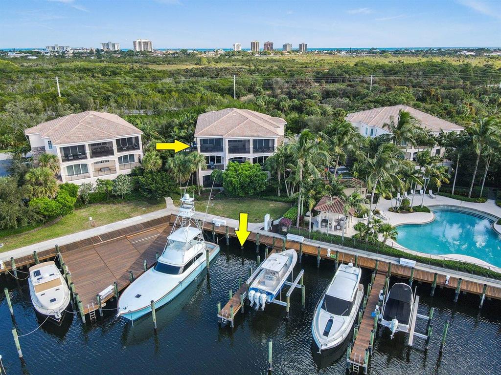 A true boater's paradise, Frenchman's Harbor is South Florida living at its finest. Boat with ease to intracoastal access and no fixed bridges, includes a 45 ft. boat slip with water/power for up to a 60 ft. vessel.  This sought after carriage home encompasses the entire third floor and offers a spacious floor plan that combines the glamour of a luxury condo with the comfort of a single-family home. Recently, remodeled in its entirety in a modern decor, this home offers direct intracoastal water views surrounded by lushly landscaped palms for complete privacy. Complete with three bedrooms, two full bathrooms, and a mixed-use dining/living space, every inch of the home was lovingly designed to make you feel right at home. The elegant floors are a rare 24'' porcelain tile. After parking in your private oversized two car garage complete with epoxy floors and storage cabinetry, you will enter through your personal elevator or your private stairway. Upon entering, you'll be greeted by an intimate foyer. The home features a true Chef's kitchen with a modern open concept. Perfect for family dining, it boasts a huge amount of quartzite surface space from the waterfall, island, and surrounding countertops. Also featuring stainless steel appliances, induction cooktop, custom soft close- and pull-out drawer cabinetry, wine fridge, and custom lighting. The kitchen leads into an open view of the private family room with sliding impact glass doors that lead to an eastern exposed covered lanai with splendid ocean breezes. The primary bedroom features a sleek sliding glass door with access to the oversized,1,000 square ft. covered lanai with brand new phantom screens. The entire home is complete with impact glass. You will find a spacious walk-in closet, as well as additional built-in closets. The private bath comes complete with jacuzzi, shower, and oversized custom mirror. It's a split floor-plan that includes a separate laundry room, equipped with a high-end washer and dryer. Frenchman's Harbor is an intimate waterfront community that consists of only 48 single family homes and 30 carriage homes and has a privately-manned gated entrance. Live walking distance to Florida's most pristine beaches with quick access to boating, water sports, fishing, fine dining and shopping. With the Jupiter inlet a mere 15 minutes away and the crystal blue waters of the Bahamas only 50 nautical miles away, this home offers the picture-perfect Floridian lifestyle about which most people only dream.