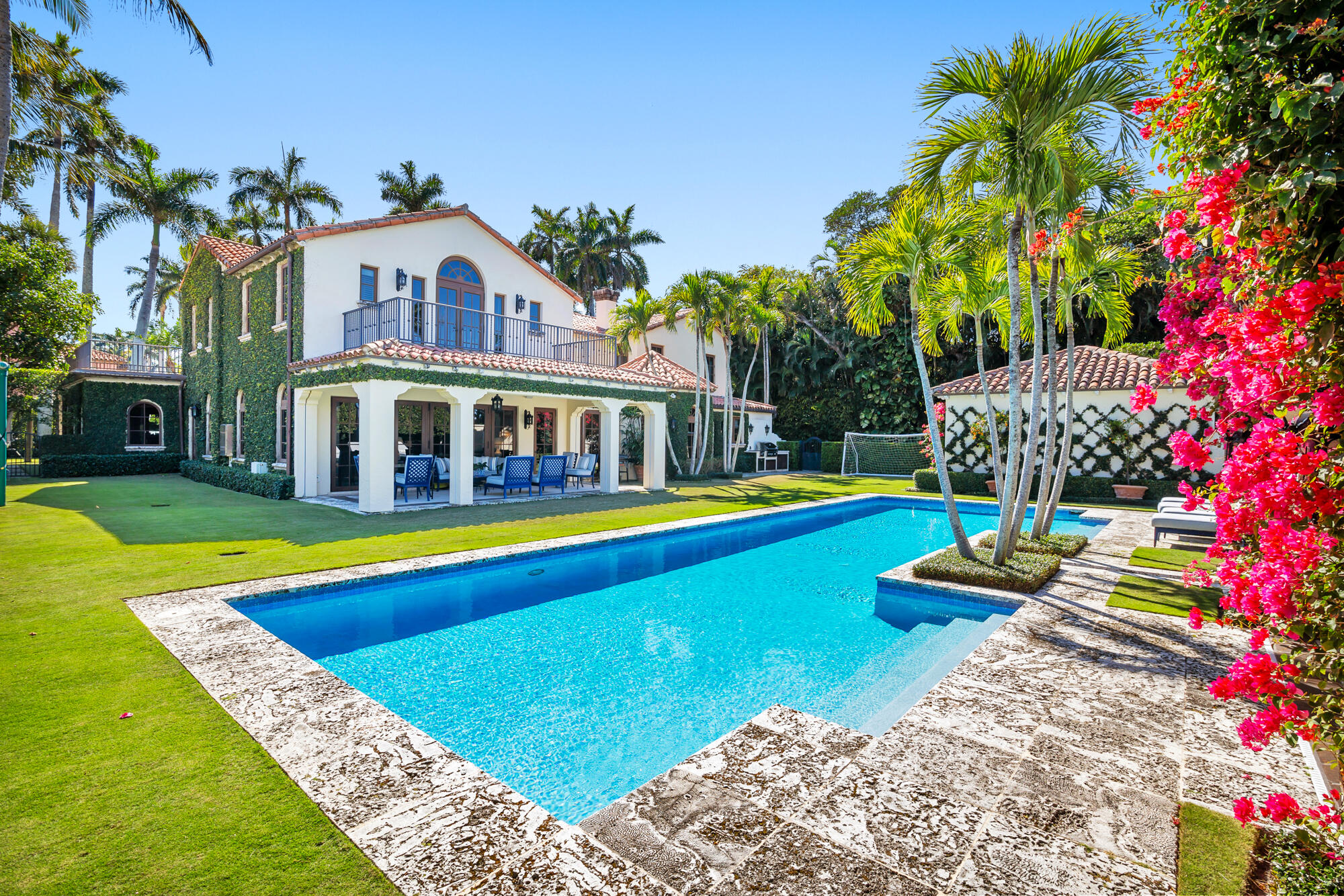 Welcome to Casa del Greco, a timeless architectural treasure designed by renowned Palm Beach architect Marion Sims Wyeth. Positioned on nearly a half-acre in Palm Beach's prestigious Estate Section, this classic masterpiece reflects extraordinary craftsmanship and enduring elegance. The two-story residence offers 4 bedrooms, 5 full bathrooms, and 1 powder room, thoughtfully designed with expansive living spaces that flow seamlessly between indoors and out. Grand entertaining rooms are complemented by refined architectural details, while the formal dining room opens to picturesque gardens and a covered loggia. Outdoors, a private oasis awaits. The resort-style pool is surrounded by lush tropical greenery and a tranquil lounge area, offering complete privacy and a serene escape (more) in the heart of Palm Beach. Casa del Greco is a rare opportunity to own a piece of architectural history, where classic Mediterranean design meets the sophistication of Palm Beach living.