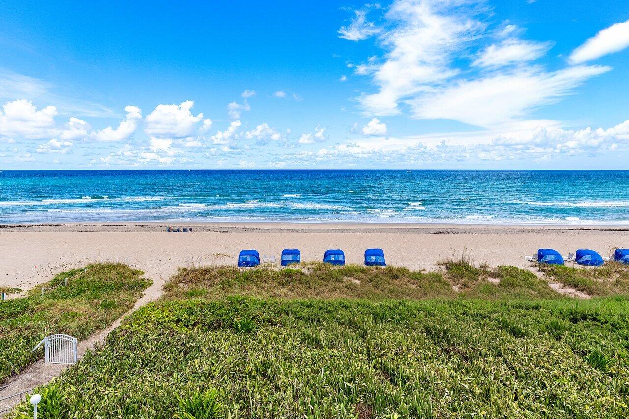 Completely reimagined in 2025, this stunning Palm Beach oceanfront residence offers the rare combination of Atlantic sunrises and Intracoastal sunsets. Featuring 2 bedrooms, 2 baths, and dual primary suites, the move-in ready split floor plan showcases over $300,000 in high-end renovations. Floor-to-ceiling hurricane-impact sliders flood the home with natural light, highlighting large-format porcelain tile, recessed lighting, electric blinds, custom cabinetry, and designer finishes throughout. The open kitchen features Calacatta quartz countertops, full-height backsplash, and Samsung Bespoke appliances. Spa-inspired baths offer floating vanities, dual sinks, walk-in showers, and LED mirrors. Enjoy a wide private beach, heated oceanfront pool, fitness center, BBQ area and beach cabanas