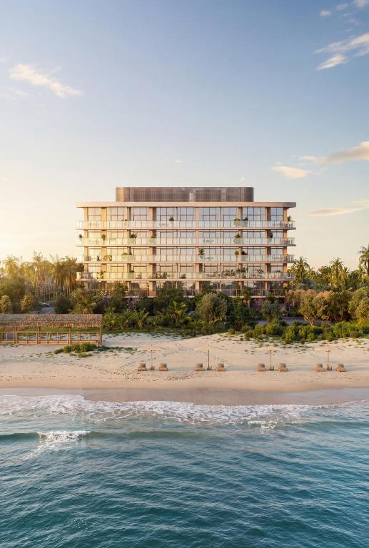 Introducing 123 Ocean.   Oceanfront Serenity. Elevated Palm Beach Shores Living.   Featuring an inviting open-plan layout with a wraparound terrace, this brand new 3-bedroom, 3.5-bathroom beach house offers a timeless coastal lifestyle close to dining, marinas, and stunning beaches. Exclusive ocean access comes via a dedicated direct walkway to the sand.   White oak, woven straw, and soft brass create a refined interior aesthetic, while a direct elevator vestibule, split-wing bedrooms, and a limited number of homes per floor maximize privacy. Here, the ebbs and flows of daily life feel effortless, private, and composed. Nothing is excessive. Everything is intentional. An elegant foyer with a convenient powder room flows into a sun-splashed living room, dining room, and kitchen with a wet bar and two exposures. Sliding doors reveal a beautiful terrace with a summer kitchen, creating a seamless villa-in-the-sky indoor-outdoor experience.   Residents can choose between two kitchen schemes suited to their lifestyle, needs, and personal tastes. Both minimalist styles are anchored by a sculptural stone peninsula and boast premium stone backsplashes, custom wood-veneer cabinetry, a walk-in pantry, and fully integrated Gaggenau appliances.   The king-size primary suite enjoys a luxurious walk-in closet, a supplementary reach-in closet, and a sanctuary-like spa bathroom with a richly veined porcelain feature wall, a custom wood and stone double vanity, curved mirrors and lighting, polished metal fixtures, wall niches with built-in lighting, light-diffusing textured glass partitions, and a walk-in rainfall shower.   The bright second and third bedrooms include reach-in closets and pristine en-suite bathrooms with a deep soaking tub or walk-in shower. Finishing the home is a thoughtful laundry room with a utility sink, storage, and a side-by-side Bosch washer and dryer.   123 Ocean is an exclusive six-story oceanfront boutique residential collection brought to life by an all-star team consisting of Lionbright Development, Arquitectonica, Asthetique, and Naturalficial. Gorgeous amenities range from arrival and building services to curated wellness and lounge spaces. Residents are welcomed by a refined porte cochère and a 24/7 attended lobby with a dedicated mail and package room. Covered underground parking is secure and maintains an elevated pedestrian environment. The resort-style pool and sun deck are gorgeous communal escapes, and the boutique fitness studio is complemented by an infrared sauna, ice bath, and treatment area. Additional highlights include a resident lounge, children's playroom, media room, and conference room.   Numerous restaurants and shops are moments away, and Palm Beach City Center and Palm Beach International Airport are just a 20-minute drive.