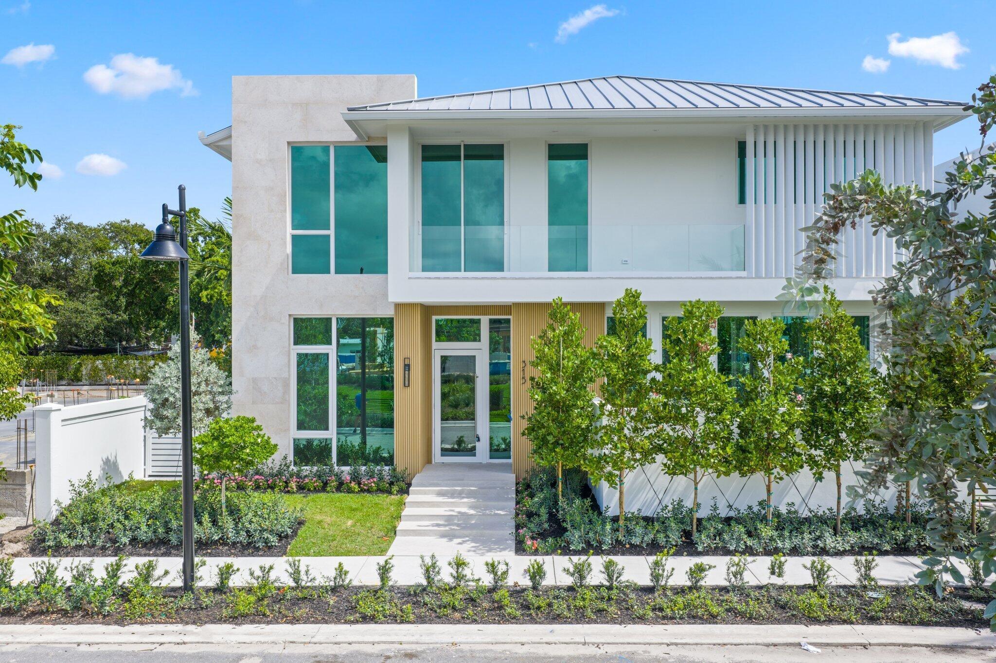 Welcome to Grove Estates — Downtown Delray's only Gated Single-Family Home Community built by award-winning Azure Development. With only 3 homes remaining in the community, this is the last opportunity to own the Serenity model in Grove Estates, which sets a new standard of luxury living in downtown Delray Beach within true walking distance to Atlantic Ave. Just over 3 blocks to Atlantic Avenue and 2 blocks to Pineapple Grove. This brand-new, modern residence offers 5 bedrooms, 5 full bathrooms, 2 powder rooms, a large, flexible club room with bar, office, lounge, & over 5,000sf of expertly crafted interior living space. Designed with clean lines, soaring ceilings, & expansive 12' floor to ceiling windows, this home is bathed in natural light & built for seamless indoor-outdoor living. Covered lanai with summer kitchen & views of the pool, with sunshelf & spa from all living areas.  Only 3 homes remain in Grove Estates, with 6 homes already sold. This home will be completed and ready for move-in in Q2 of 2027. 330 Grove Pl is a Serenity Farmhouse, but can be customized with mixtures of finishes from the Serenity Modern, if you contract soon.  Designed by celebrated architect Randall Stofft and curated by Czar Interiors, the Serenity model spans 5,192 square feet of air-conditioned living with over 6,300 total square feet of resort-style space. Soaring 12-foot floor-to-ceiling glass windows invite light and lush greenery into every corner of the home, creating a seamless connection to the outdoors. The dramatic floating staircase and private elevator offer both modern flair and convenience, while the thoughtful layout effortlessly blends entertaining and everyday living.  The gourmet kitchen is a chef's dream, outfitted with Wolf and Sub-Zero appliances, custom 12-foot cabinetry, and a hidden butler's pantry. An expansive club room offers full front and back bars and expansive glass doors that open completely to the outdoors, perfect for hosting or relaxing in style.  Step outside into your own private oasis with an oversized saltwater pool, spa and sunshelf surrounded by dense, tropical landscaping for total privacy. The covered outdoor living area features a full summer kitchen, wood-clad ceilings, and concealed retractable screens, allowing for effortless indoor-outdoor entertaining no matter the season. Upstairs, expansive balconies with glass railings overlook the lush central green, a landscaped park exclusive to Grove Estates, ideal for peaceful walks, yoga, or simply taking in the tranquility.  Upstairs, 4 spacious bedrooms include a luxurious VIP suite and a stunning primary retreat, each designed with custom finishes and spa-like bathrooms. A three-car garage, solid steel and concrete second-floor construction, natural gas fireplace, and designer fixtures round out this exceptionally built home that merges quality with artistry at every turn.  With unmatched design, rare privacy, and a location just steps from the energy of downtown Delray, this is your opportunity to claim one of the most exclusive addresses in South Florida. These finished photos are of a completed Serenity Farmhouse in Grove Estates.