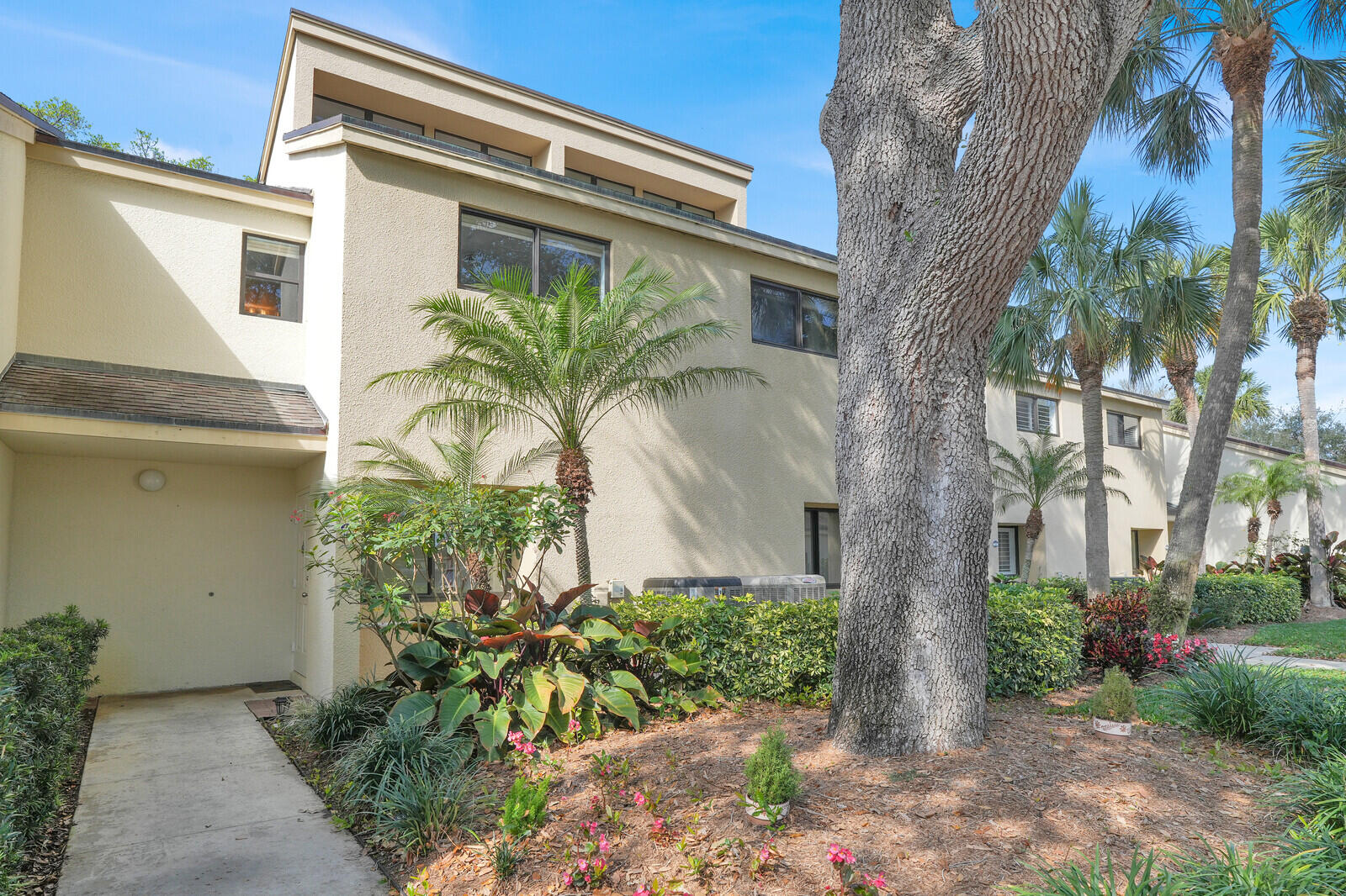 Discover effortless coastal living in this beautifully maintained 2-bedroom, 2.5-bath townhouse nestled within the gated waterfront community of Oak Harbour in Juno Beach. Designed for comfort and privacy, both upstairs bedrooms are spacious suites, including a serene primary retreat with its own private balcony and generous attic storage. The open living and dining areas create a warm, inviting space to relax or entertain, while the screened patio overlooks lush, mature landscaping for peaceful indoor-outdoor living. Move-in ready with granite kitchen countertops and timeless finishes, this home offers access to resort-style amenities, marina slips, pools, fitness center, tennis and pickleball--all just minutes from the beach, dining, and shopping.