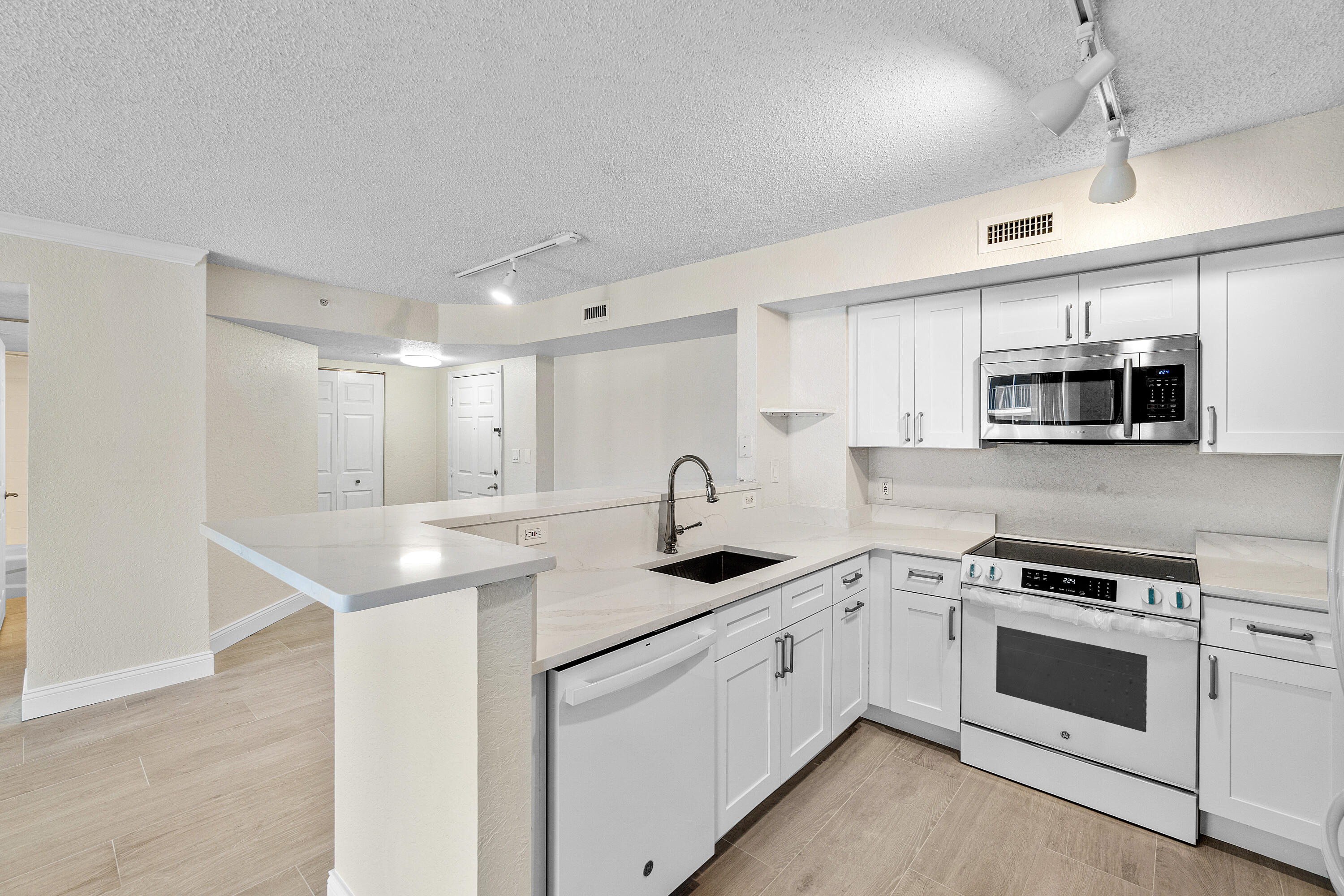 Fully renovated and available for lease, this stunning high-floor residence at Flagler Pointe offers breathtaking Intracoastal, pool, and garden views. The desirable split-bedroom floor plan features new white oak-look porcelain plank flooring, fresh paint, updated kitchen appliances, and beautifully renovated spa-inspired bathrooms. The bright living and dining areas open to a private balcony, perfect for enjoying the waterfront scenery. The spacious primary suite offers incredible views, dual closets, and an updated bath, while the guest suite provides privacy and easy access to the second full bath. Complete with full-size washer and dryer and ideally located just minutes from Downtown West Palm Beach, Palm Beach Island, shopping, dining, and beaches