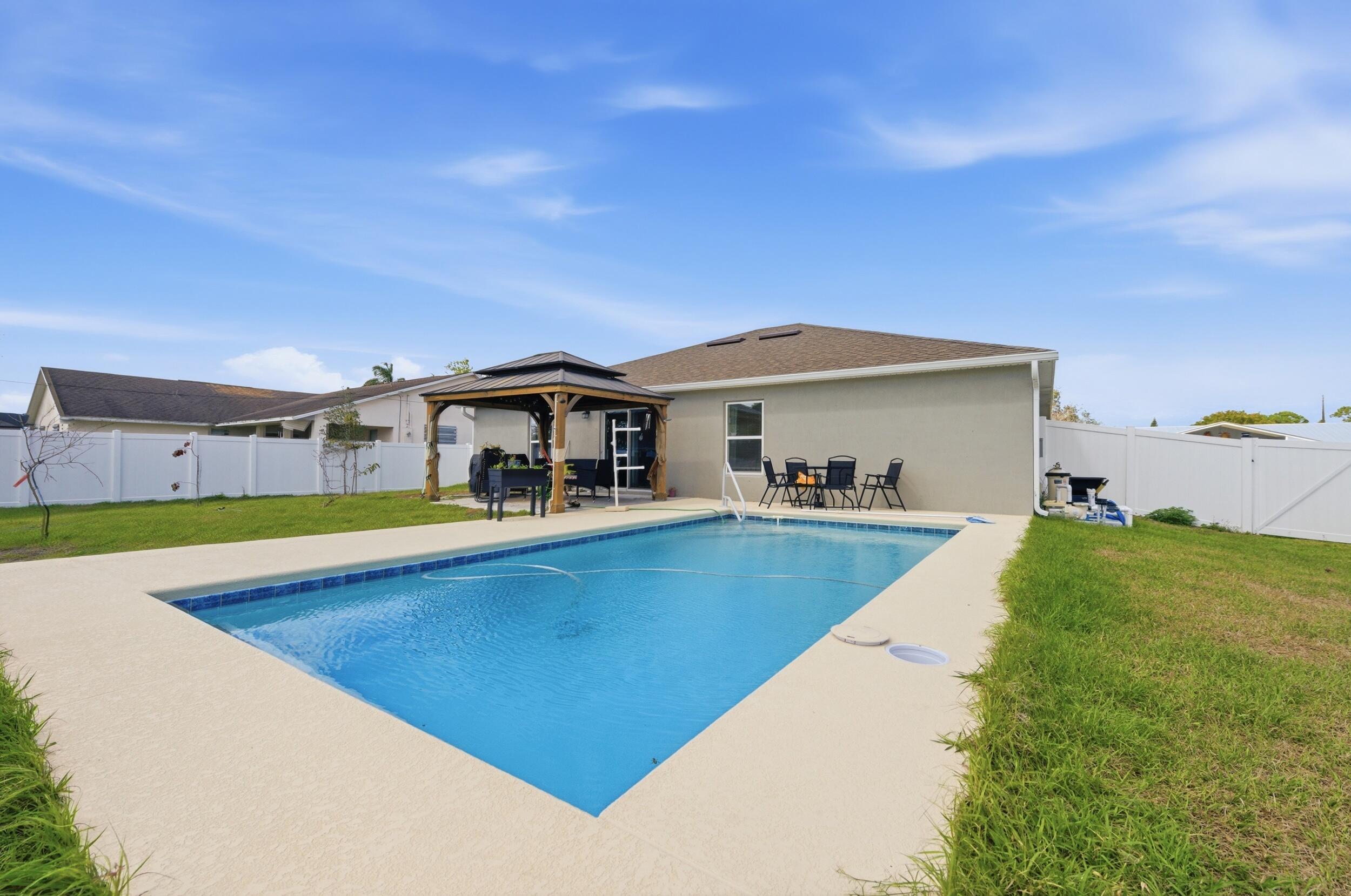 MOVE IN READY POOL HOME! BRING OFFERS! Why wait to build? Enjoy peace of mind in this 2024 home with a pool, featuring 3 bedrooms, 2 bathrooms, and a 2-car garage with attractive stone accents on the front exterior. The kitchen boasts a stylish backsplash and an open flow and functional layout. Step outside to a 12x24 pool completed in 2025, with a sitting ledge, app-controlled automatic cleaning system, programmed control box, and pool equipment including a pool vacuum. A white vinyl fence (2025) adds privacy. Dont miss your chance to get into a newer home with a pool, this doesn't happen often. Great Location to amenities, restaurants, and the Port District.