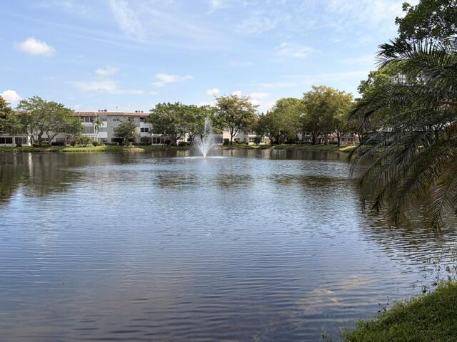 Beautiful corner unit located on the first floor in a desirable 55+ community! This well-maintained 2-bedroom, 2-bath condo features a relaxing lake view and plenty of natural light. The building has already passed the 40-year inspection, offering added peace of mind. Spacious layout, great condition, and conveniently located near shopping, restaurants, and major highways. Enjoy quiet and comfortable South Florida living at its best!