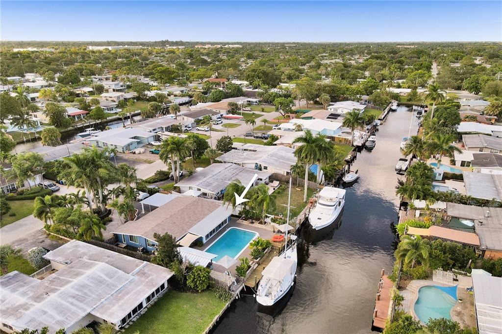 Your Tropical Paradise 3BD 2BA Waterfront Pool home you have been waiting for.  Property features an Open Floor Plan with white porcelain tile throughout, split floor plan, vaulted wood beam ceilings, Impact Windows and Doors (2018) and easy-close hurricane concertina shutters for the back portion of the property.  Fully fenced back and sides.  Exterior has been professionally refinished and painted (2021). New Roof in 2020, 65ft of Ocean Access Waterfront with a New 45ft boat dock (Oct 2021).  Move in ready!  Come relax in your 32x16x9 Saltwater Pool, or at the lovely outdoor seating areas and tiki hut having a nice cold beverage in the shade.  Minimal yard maintenance, & mature tropical landscaping.  NO FIXED BRIDGES to ocean access and cruising the waterways around the area!