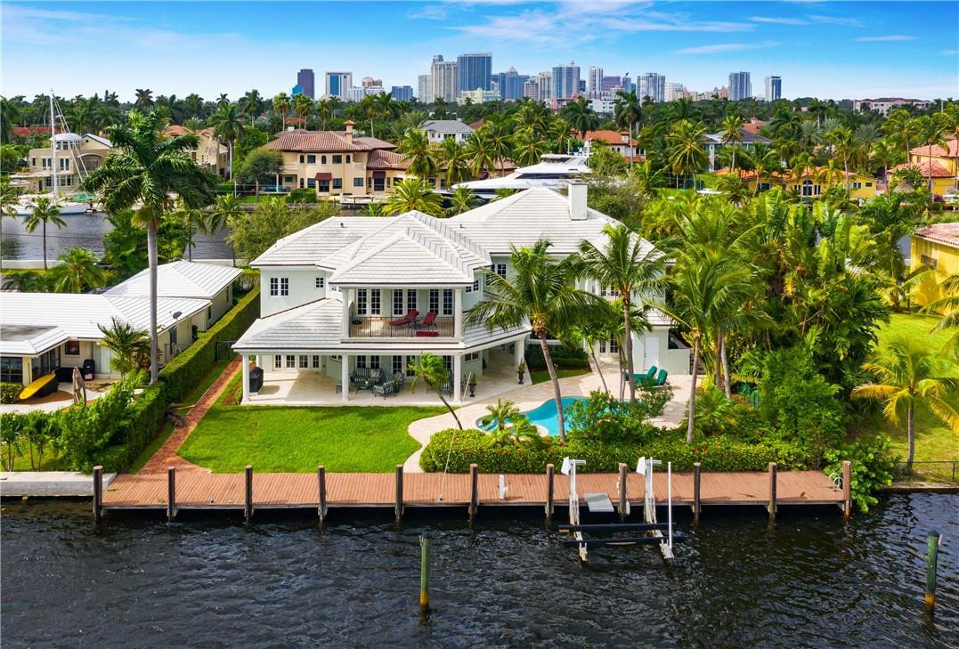 Not to be overlooked if you are seeking wide open views under $6M.  This elegant Georgian-inspired water wonderland has additional privacy with no residence across the isle and 100ft of waterfront views! Unequalled almost every room in this home has a water view Enjoy the highly unique deepwater ocean access PLUS wide open lake views. The opportunities for water activities are endless! Great protected dockage with electric, water and 15,000lb boat lift, kayak, paddleboard etc. This timeless traditional two-story, 6 bedrooms, 7 1/2 bath home shows beautifully. Over 5,000SF of indoor living space, expansive outdoor living with pool, hot tub and covered loggia. Great floorplan includes a first level home office, VIP guest suite, separate in-law/captains/nanny quarters. Must see to appreciate!