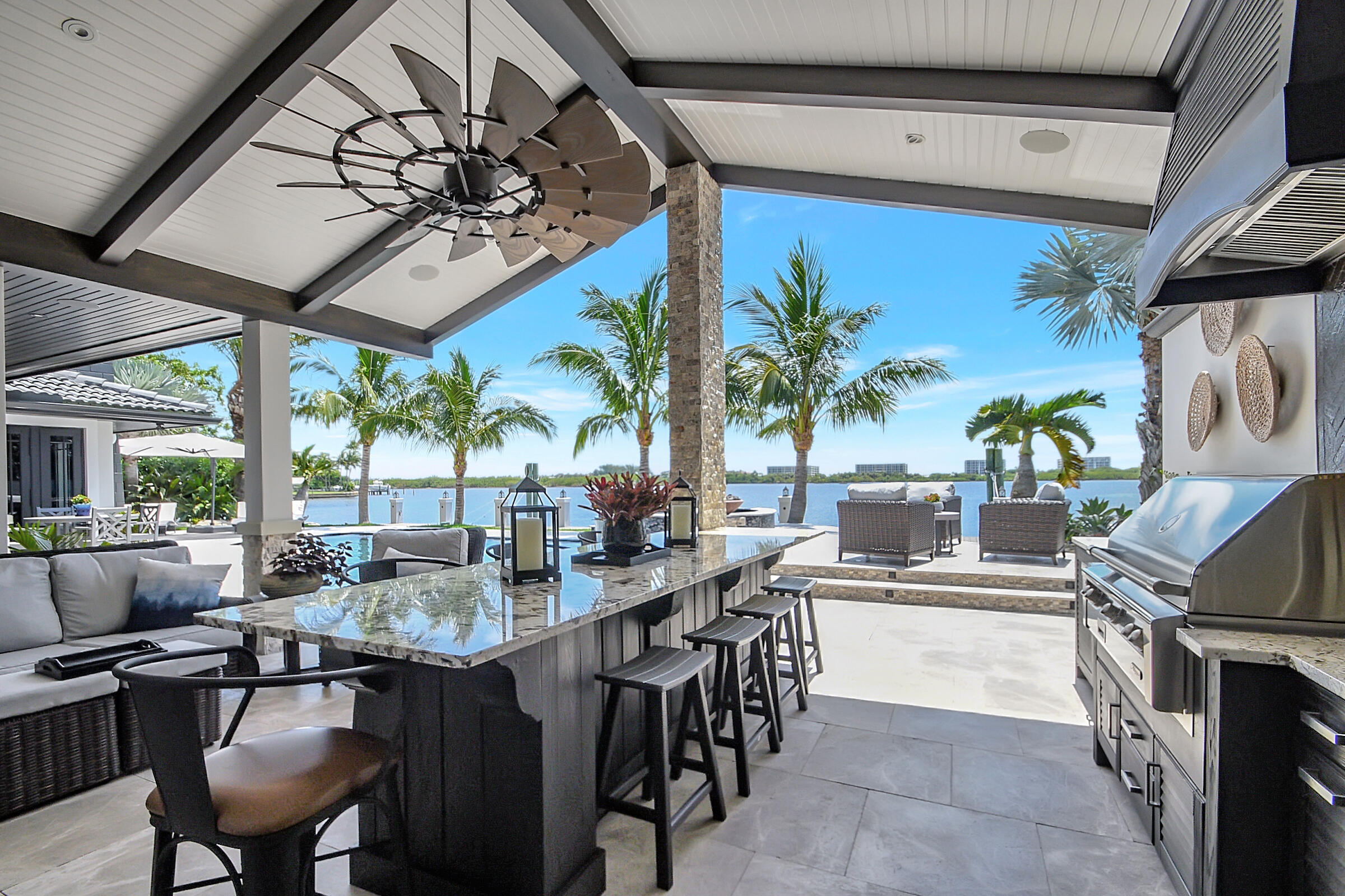 WOW—prepare to be captivated from the moment you enter. Sweeping, unobstructed Intracoastal views create a truly breathtaking first impression. Boaters will appreciate the ability to dock up to a 100-foot yacht on direct Intracoastal frontage. Pass through a distinctive pecky cypress gate into a charming courtyard that opens to a private, tranquil oasis. Designed for both relaxation and entertaining, the home offers exceptional privacy paired with refreshing ocean breezes. The expansive east-facing backyard features a resort-style pool and spa overlooking Palm Beach Island—perfect for enjoying stunning sunrises and cooling coastal winds. Inside, a spacious kitchen seamlessly flows into the great room, where abundant French doors create effortless indoor-outdoor living and entertaining.  deally located, enjoy scenic strolls along Flagler Drive with easy access to the renowned dining, shopping, and nightlife of Palm Beach Island, downtown West Palm Beach, and Clematis Street. This home embodies a rare blend of serenity, sophistication, and waterfront luxury. Welcome home.