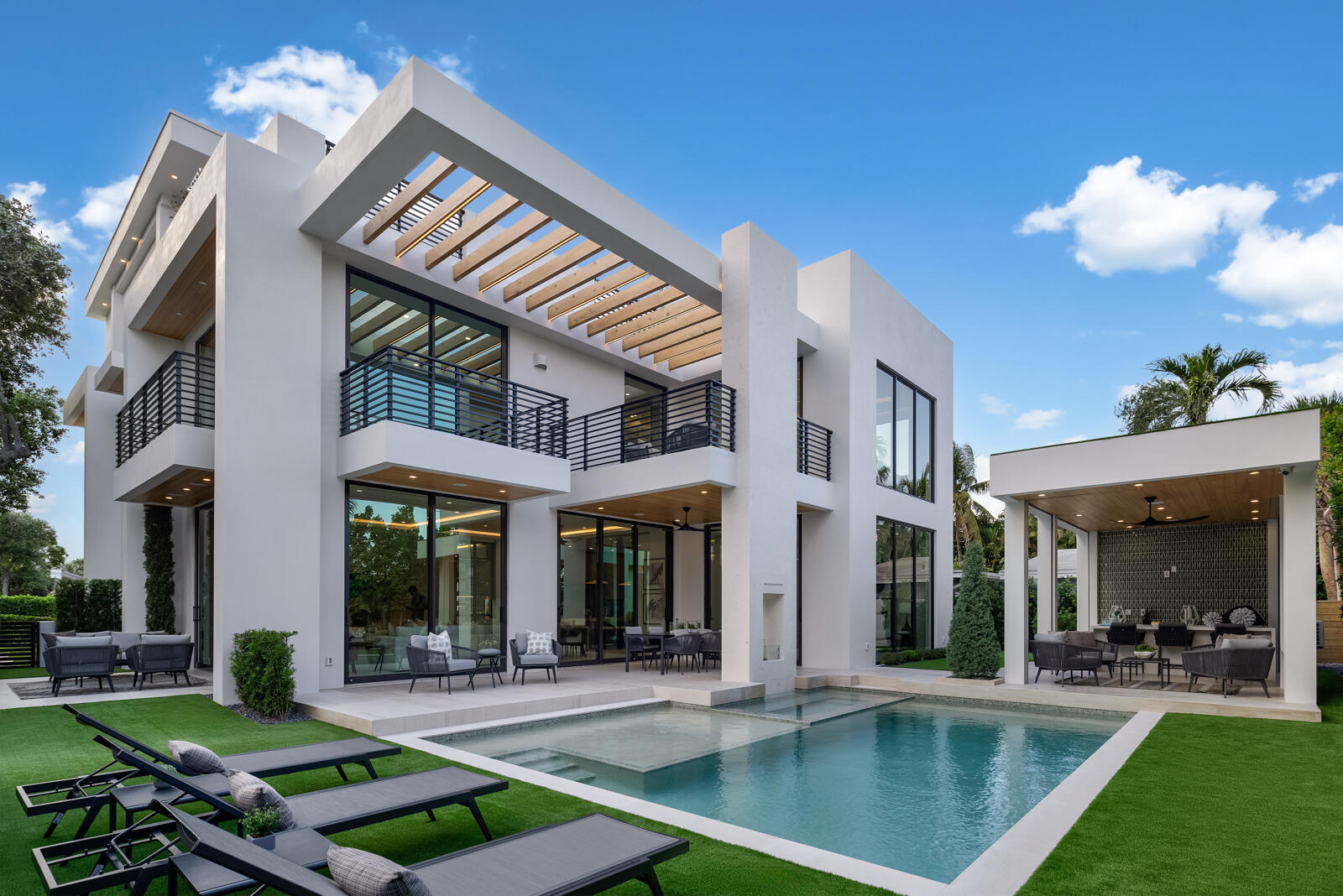 Unveiling an architectural triumph in East Boca Raton an exquisite three-story sanctuary where innovation meets timeless sophistication. Designed to inspire and built to impress, this newly constructed estate of distinction offers six lavishly appointed bedrooms, six full baths, and three refined powder rooms, each space curated with an unparalleled level of craftsmanship and attention to detail.

A grand entrance welcomes you into a world of effortless luxury, where 12-foot ceilings soar above limestone floors, reflecting the soft glow of cove lighting that artfully enhances the home's contemporary lines. A private study sits just beyond the foyer, offering a tranquil retreat for moments of focus and inspiration. Nearby, a gracefully positioned floating staircase ascends toward the upper levels, while an elevator glides seamlessly between floors, ensuring both convenience and grandeur.

At the heart of the home, a culinary atelier awaits. Designed for the epicurean at heart, the gourmet kitchen is a symphony of the world's finest appliances: a Wolf range, Miele microwave and oven, Dacor refrigerator and freezer, and an integrated Miele coffee system to perfect the art of the morning ritual. An elegant butler's pantry, discreetly outfitted with a Miele dishwasher, secondary sink, and generous storage, allows for seamless entertaining. A wine refrigerator, ice maker, and mini fridge cater to the connoisseur, ensuring that every occasion is met with effortless hospitality.

On the first level, a serene guest suite with a private en-suite bath provides an intimate haven of comfort. Step outside, and a world of alfresco indulgence unfolds. The covered cabana, adorned with a built-in wet bar and summer kitchen, sets the stage for evenings of fine dining under the stars. A detached cabana bath, artfully positioned for poolside convenience, enhances the seamless indoor-outdoor lifestyle.

The second level is a private sanctuary, where four resplendent en-suite bedrooms redefine modern elegance. The primary suite, a true retreat, boasts a bespoke built-out closet with island, while its spa-inspired bath invites moments of pure serenity. A second level living area offers a stylish and comfortable space for relaxation or gathering, enhancing the home's functionality and flow. Throughout this level, European white oak flooring lends an air of warmth and refinement, complementing the home's masterful design. 

Ascending to the third floor, a multifunctional retreat ideal as a guest suite, private gym, or artist's studio features a full en-suite bath and leads to a crown jewel of the residence: the expansive rooftop terrace. With an outdoor kitchen and panoramic vistas, this private haven is the ultimate backdrop for sunset soirées and moonlit revelry.

Every element of this estate has been meticulously conceived for both form and function from the generator-ready infrastructure and three-zone climate control to the lift-ready garage and natural gas utilities. Quartz countertops, handcrafted millwork, and masterfully curated lighting converge in a home that is as breathtaking as it is livable.

A statement of modern grandeur, this extraordinary residence is a rare offering an invitation to experience Boca Raton living at its most exquisite.