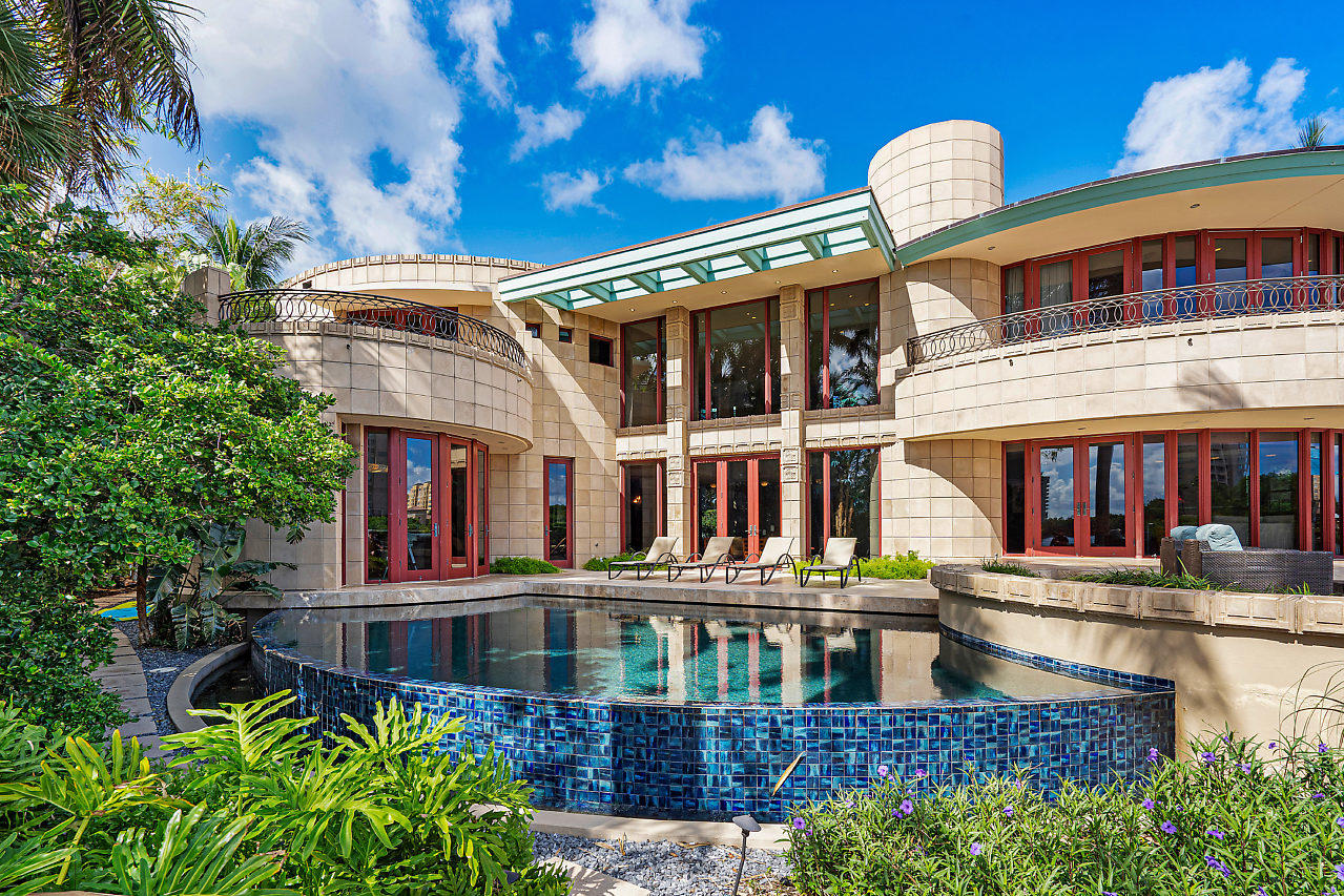 Dos Lunas is a Masterpiece estate directly on the Intracoastal Waterway. This dream home was designed and decorated by owners Derek and Lisa Vander Ploeg and took over 3 years to build. This Frank Lloyd Wright inspired vision has 4 Bedrooms plus Den or Office/7 Bathrooms, beautiful custom kitchen featuring Mahogany Cabinets, state of the art appliances and custom Rainforest marble countertops. The 4300 Sandstone wall tiles featured on the exterior and interior walls in addition to the ''Noce'' travertine (glossy inside and honed outside) all contribute to the indoor-outdoor natural flow. Infinity edge pool, 60' foot dock, whole home Generator, underground 500 gallon propane tank, two fireplaces, The ''two moon'' design is evident in the curvature of the Master Bedroom Suite.