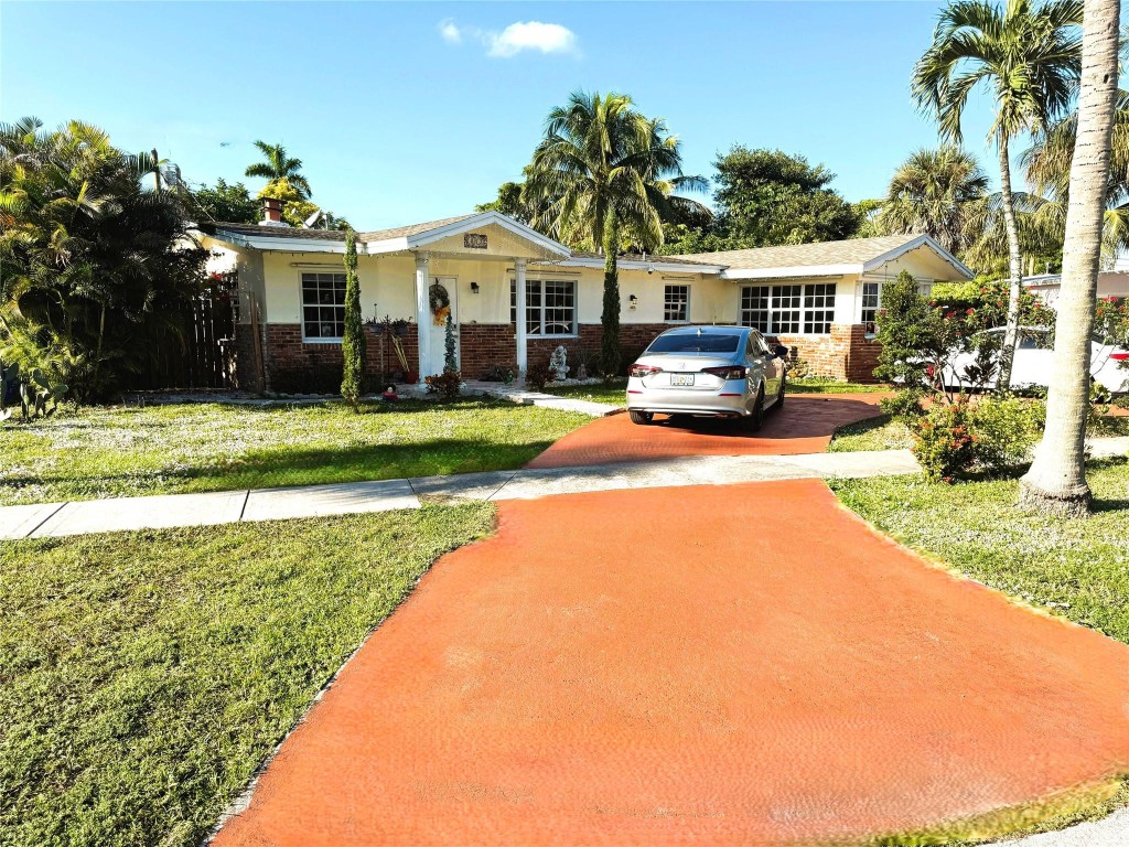 Beautifully updated, bright 4BR/2BA Margate pool home with fenced-in back yard! Perfect for kids and pets. The spacious split floor plan flows effortlessly.  Circular driveway fits 5+ cars. No HOA. 2 Large Sheds for storage for bikes, equipment, and tools. Stunning updated kitchen with quartz countertops, stainless steel refrigerator and dishwasher, a sleek cooking hood, soft-close cabinetry, and a large sink. Beautiful tile floor and large laundry room.Working fireplace, a light-filled sunroom, and an inviting family room. Three bedrooms open directly to the back patio. The primary suite features double French doors that frame the sparkling pool. Amazing travertine pool deck, artificial grass play area, and a shaded corner for barbecuing.