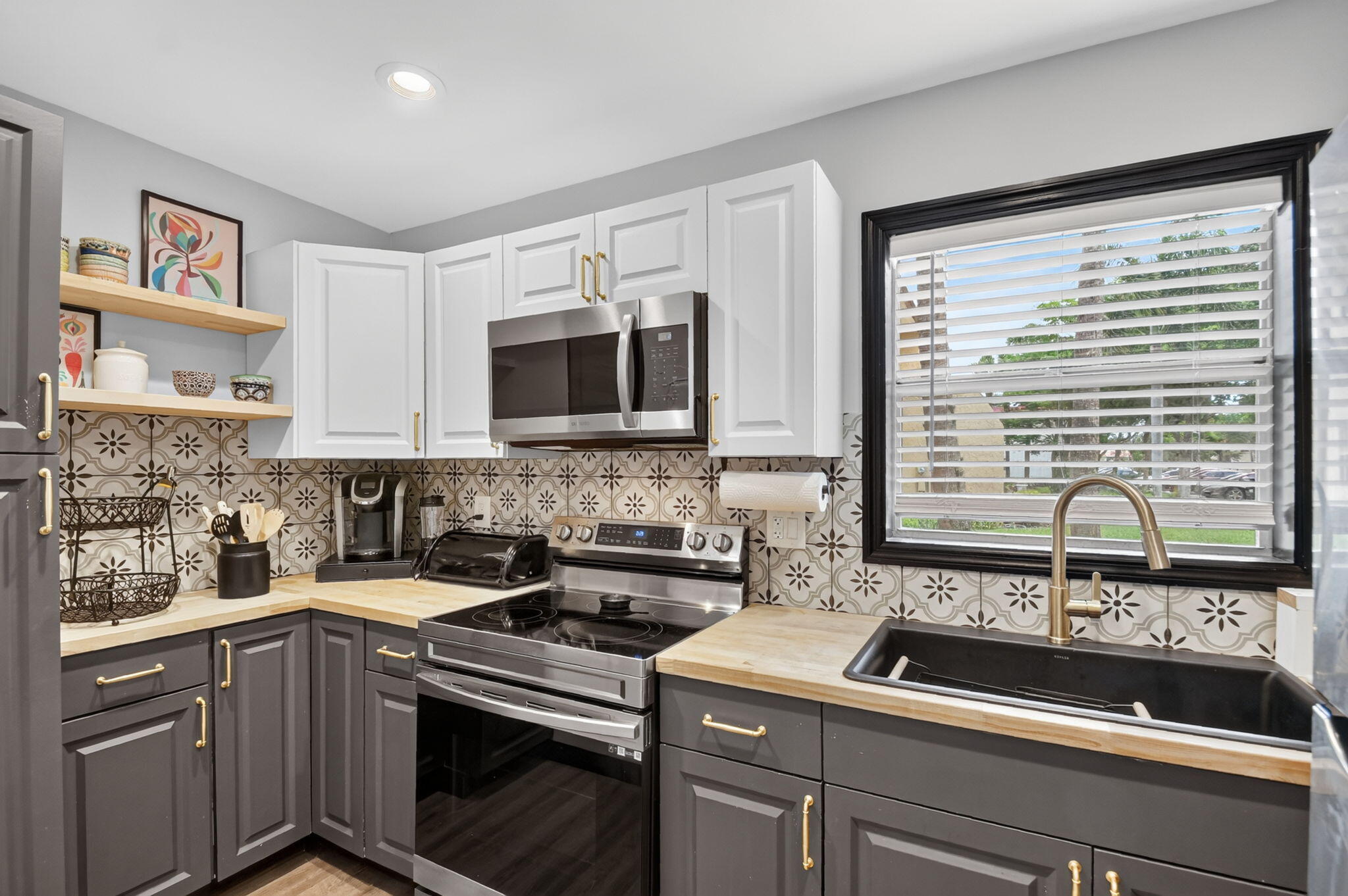 Beautifully remodeled first-floor corner condo in the guard gated, 55+ community of Golden Lakes, Phase A—fully furnished and move-in ready! Features new flooring, updated kitchen and bath, and top-of-the-line appliances. Enclosed glass patio adds extra bright living space. Spacious bedroom with walk-in closet, custom shelves, cabinets, and great storage. Enjoy low-maintenance living with amenities including fitness center, tennis, lakefront pools, and  a courtesy shuttle bus, with a calendar full of activities to keep you engaged.  Low HOA and great location, close to PBI, and beaches—don't miss this rare decorator furnished move-in ready opportunity!