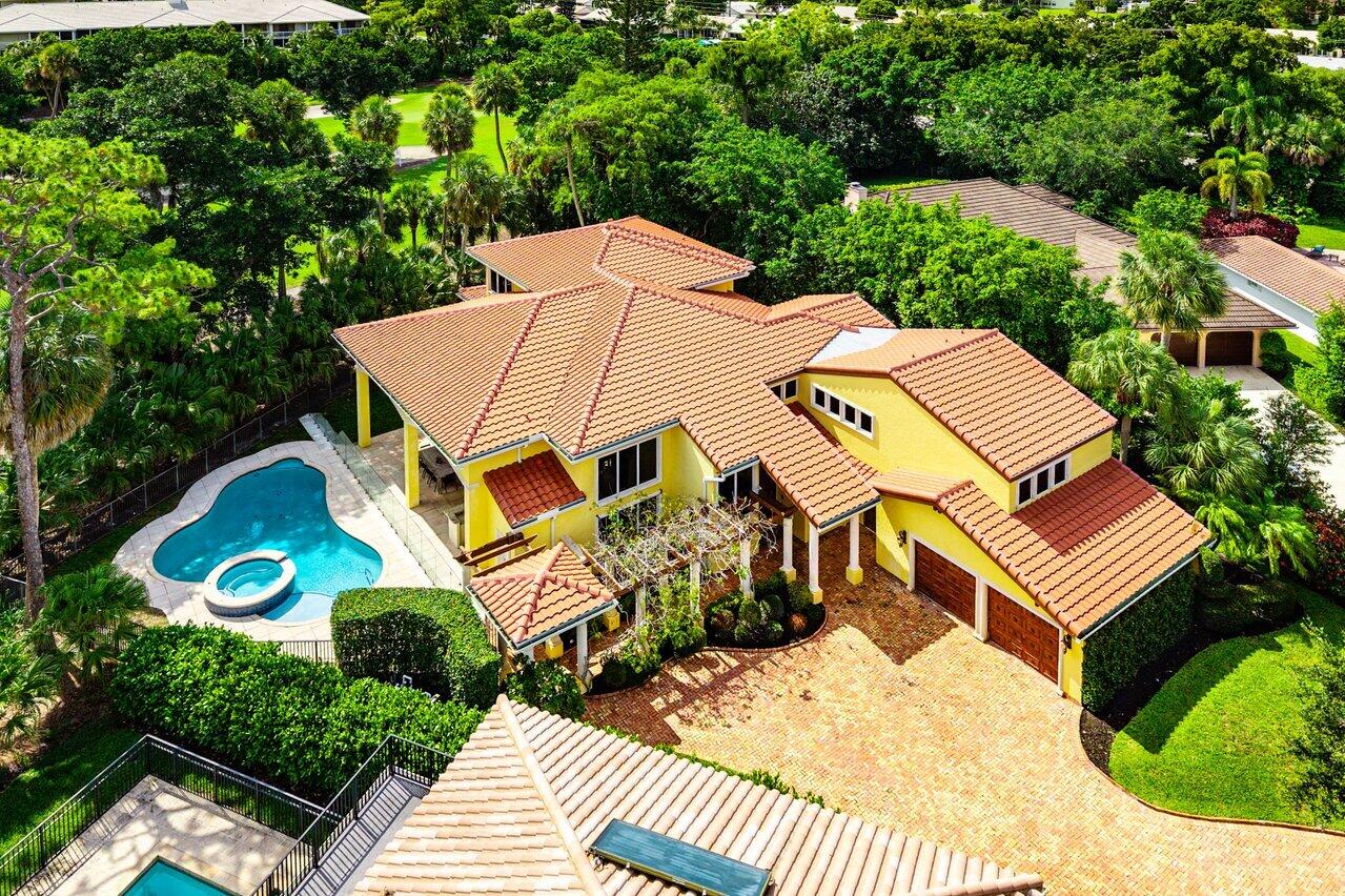 Stunning 6-bedroom, 5-bathroom, 2-half-bath estate overlooking the newly redesigned Signature Jack Nicklaus Golf Course in Whispering Woods, an intimate enclave of just 34 homes in central Boca Raton. Positioned on a coveted corner lot, the property enjoys expansive golf course views, exceptional privacy, and abundant outdoor space rarely found in country club communities. Ideally located just 10 minutes from the beach and moments from Town Center at Boca Raton, premier dining, and everyday conveniences, this residence offers the perfect balance of luxury and location. Recently renovated with beautiful white oak flooring and high-end finishes throughout, the home welcomes you with soaring volume ceilings and dramatic windows that flood the living spaces with natural light.  The chef's kitchen is thoughtfully designed for both everyday living and entertaining, featuring custom wood cabinetry, quartz countertops, a farmhouse sink, Viking refrigerator, wall oven, and an impressive 8-burner gas range. Nearby, the expansive family room offers high ceilings, French doors, and seamless access to the outdoor living areas, creating an effortless indoor-outdoor flow. Additional highlights include a wet bar, custom built-ins, breakfast area, spacious laundry room with double LG ThinQ washers and dryers, Ecobee smart home technology, a whole-house generator, two brand-new air handlers, and a new roof completed in December 2025. Designed with modern sophistication and comfort in mind, the home features two spacious primary suites, one on each level. The upstairs primary retreat spans approximately 1,200 square feet and is surrounded by corner windows that frame sweeping golf course views, creating a peaceful setting for every morning. Its beautifully renovated bathroom offers a spa-like experience, while the first-floor primary suite provides ideal accommodations for guests or multigenerational living. Four additional upstairs bedrooms and a loft with dedicated office space complete the second level. Outside, a resort-style backyard delivers the ultimate South Florida lifestyle. Enjoy a beautiful pool and spa, full outdoor kitchen, multiple covered patio areas for dining and lounging, and generous side yard space made possible by the oversized corner lot. Whether hosting large gatherings or enjoying a quiet evening overlooking the golf course, the outdoor spaces are designed to maximize both comfort and scenery.