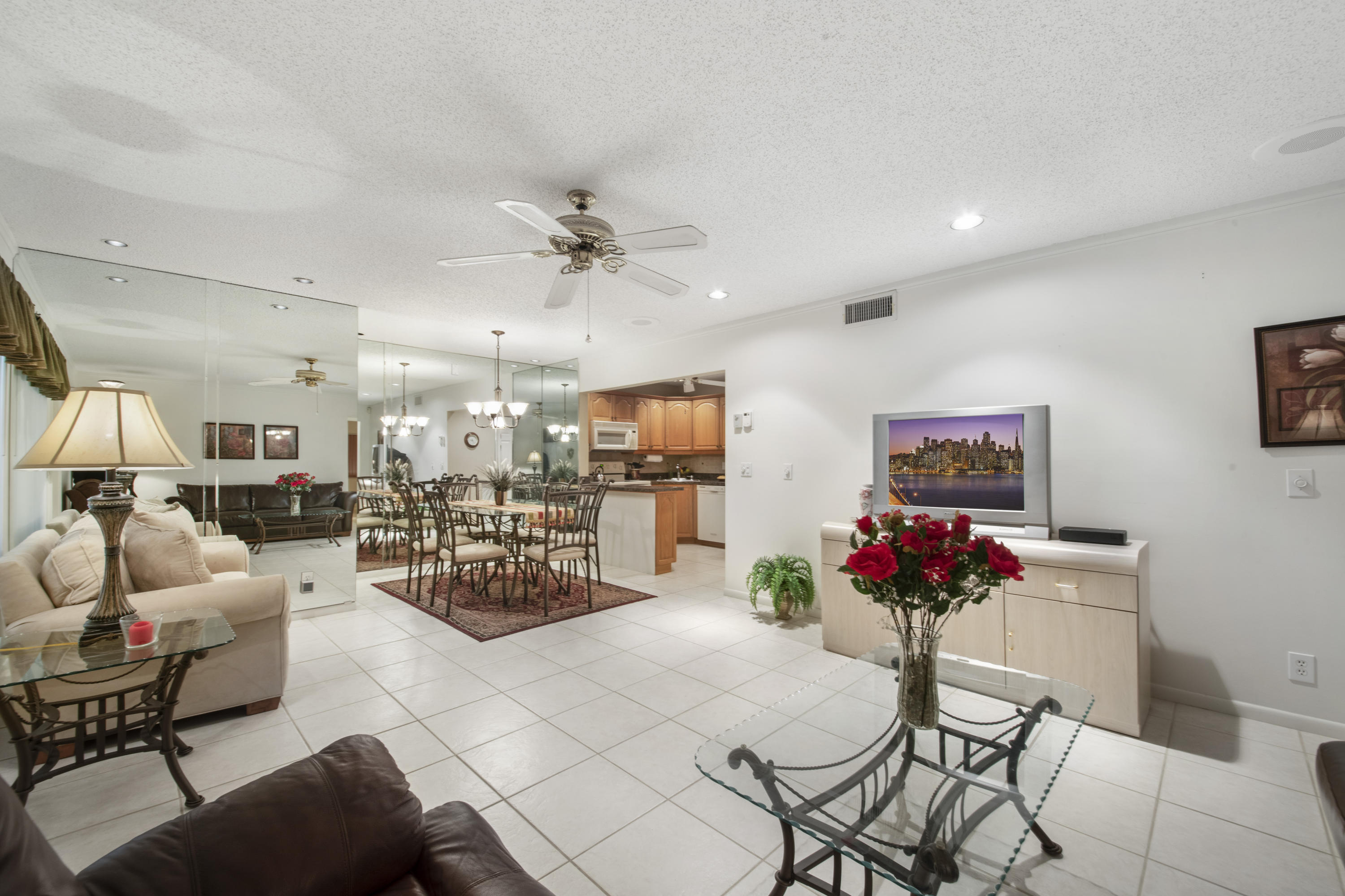 This Beautiful Condo Assoc is for 55+. UNFURNISHED 2 bedroom, 2 bath, bright corner unit has so much to offer. Beautiful Kitchen cabinets and bathrooms! Ceramic Tile floor in living areas with soft carpet in the bedrooms; Walk-In Closets in Both rooms; Full Size washer and dryer. Enjoy Peaceful Green Belt Views from your FLORIDA ROOM/ PATIO, & exterior storage closet. IMPACT GLASS WINDOWS & Plenty of parking for guests or relatives. Walking distance to clubhouse and pool! Senior community that offers a fun lifestyle, from quiet walks around the lake, sitting out on your screened in porch, playing bingo or cards, Bocce Ball, Tons of Social Activities & Clubs. This home is also Offered Furnished & TURN KEY!! Bring your toothbrush & Suite case! ** ALL Adults Must Be 55 Yr Old **