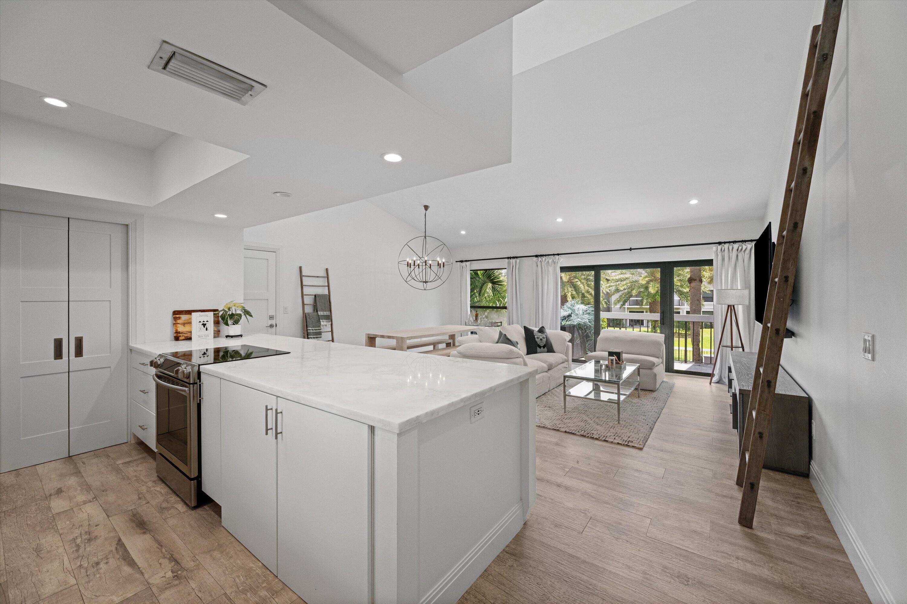 Experience sophisticated, turn-key living in this beautifully renovated 2-bedroom, 2-bathroom condo. The bright, open-concept interior features soaring vaulted ceilings and magnificent natural light pouring through high-impact glass windows and sliding doors. A sleek chef's kitchen boasts a massive marble island, premium finishes, and seamless flow into a spacious living area. Unwind in the stunning primary suite, complete with a dramatic statement chandelier and a spa-like double vanity bath featuring a custom glass-enclosed shower. Enjoy peaceful golf-cart community living, secure impact protection, and top-tier modern design. A perfect seasonal retreat or equestrian permanent residence.