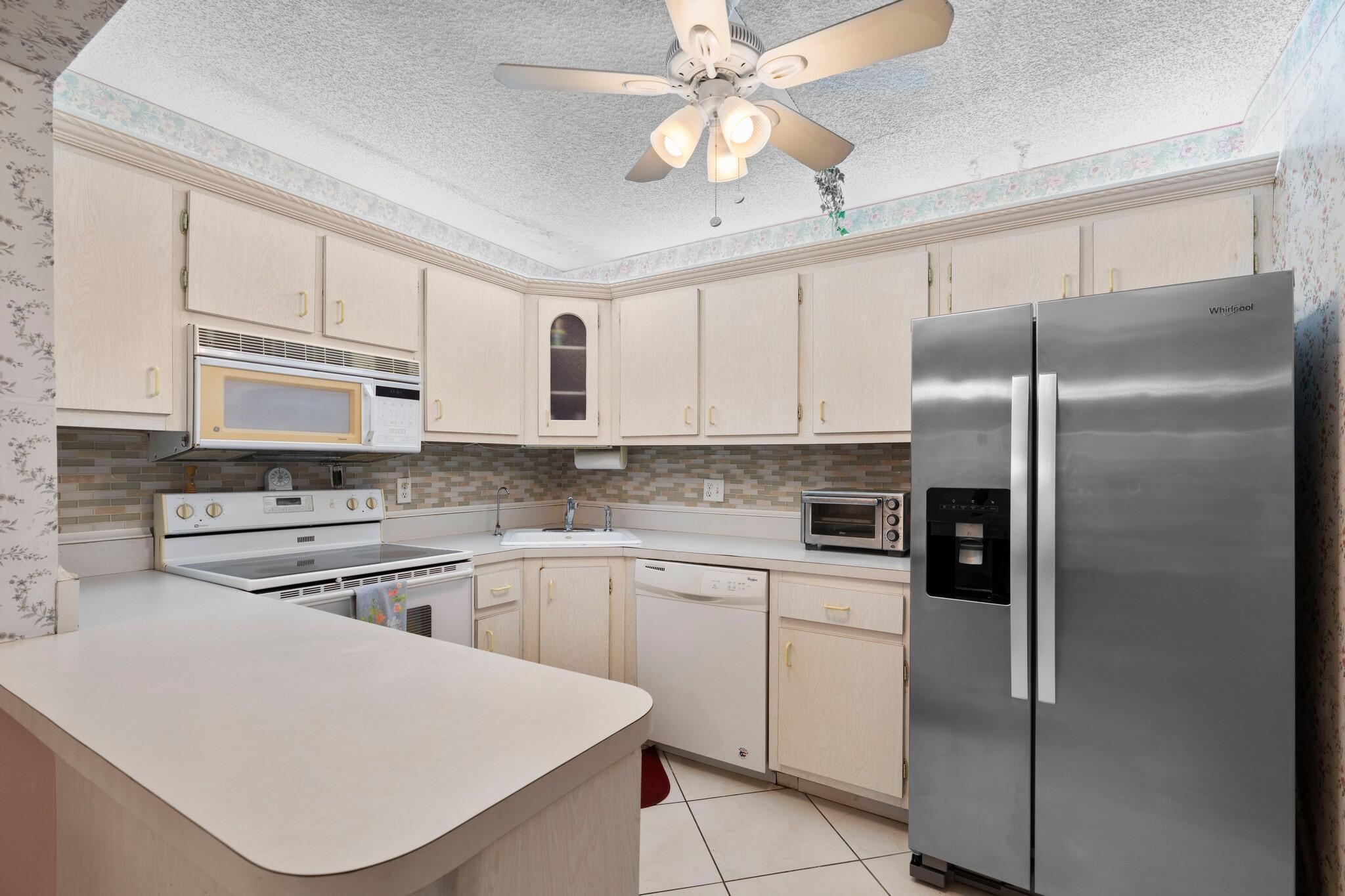 Resort-style living at Pine Ridge III in the Sunshine State. Move right into this furnished 2-bedroom, 1-bath condo located on the 1st floor in an active 55+ community. Enjoy morning sun & peaceful surroundings from a private rear-building location. Pine Ridge III, a hidden gem with affordable monthly fees offers an array of amenities including pickleball, tennis, shuffleboard, bocce, social room, library & luncheons hosted by the Men's & Women's Clubs. Relax or swim laps in the heated pool. Designated parking space is located near your walkway with ample guest parking available & a convenient car wash area. Ideally situated near world-class shopping, golf, beaches, cultural activities, medical facilities & Palm Beach International Airport. All furnishings are included w the purchase.