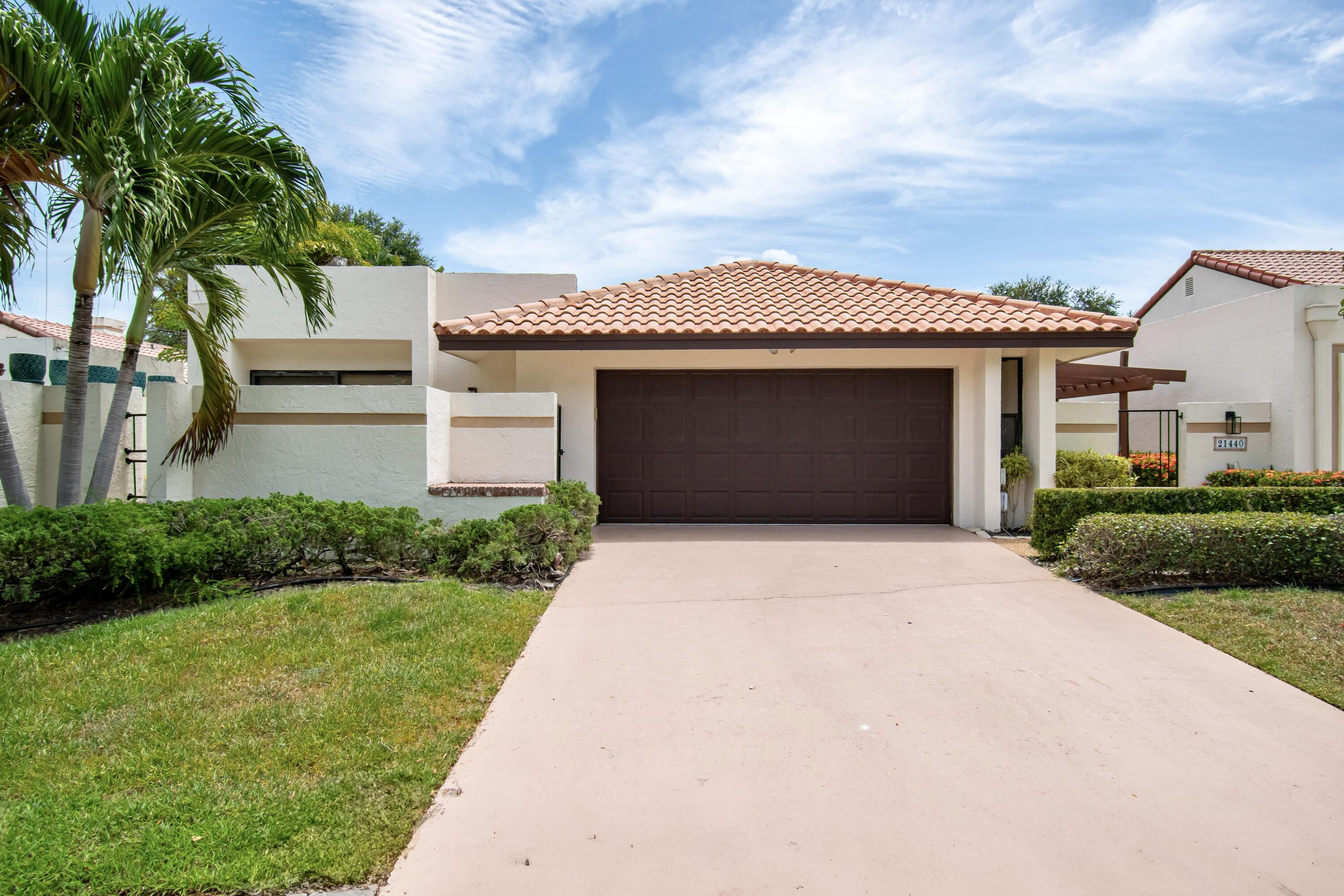This beautifully updated 3-bedroom, 2-bathroom residence offers approximately 2,000 square feet of thoughtfully designed living space, featuring soaring vaulted ceilings, an open-concept layout, and an abundance of natural light throughout. The stylish contemporary white kitchen is a true centerpiece, showcasing elegant quartz countertops, stainless steel appliances, and a generous eat-in area ideal for casual dining and entertaining. The beautifully renovated bathrooms feature modern finishes and a sleek aesthetic, while luxury vinyl flooring extends throughout the main living areas, providing a perfect blend of sophistication and everyday durability. A flexible bonus room located just off the living room offers endless possibilities as a home office, media room, playroom, or private  retreat. Additional highlights include a convenient in-unit washer and dryer, along with a beautifully finished outdoor space designed for relaxing, entertaining, and enjoying the Florida lifestyle. Take advantage of low HOA fees and an unbeatable location within walking distance to A-rated schools and houses of worship. Ideally situated near upscale shopping, popular dining destinations, parks, and major highways, this exceptional move-in-ready home delivers the perfect balance of modern comfort, convenience, and timeless appeal.