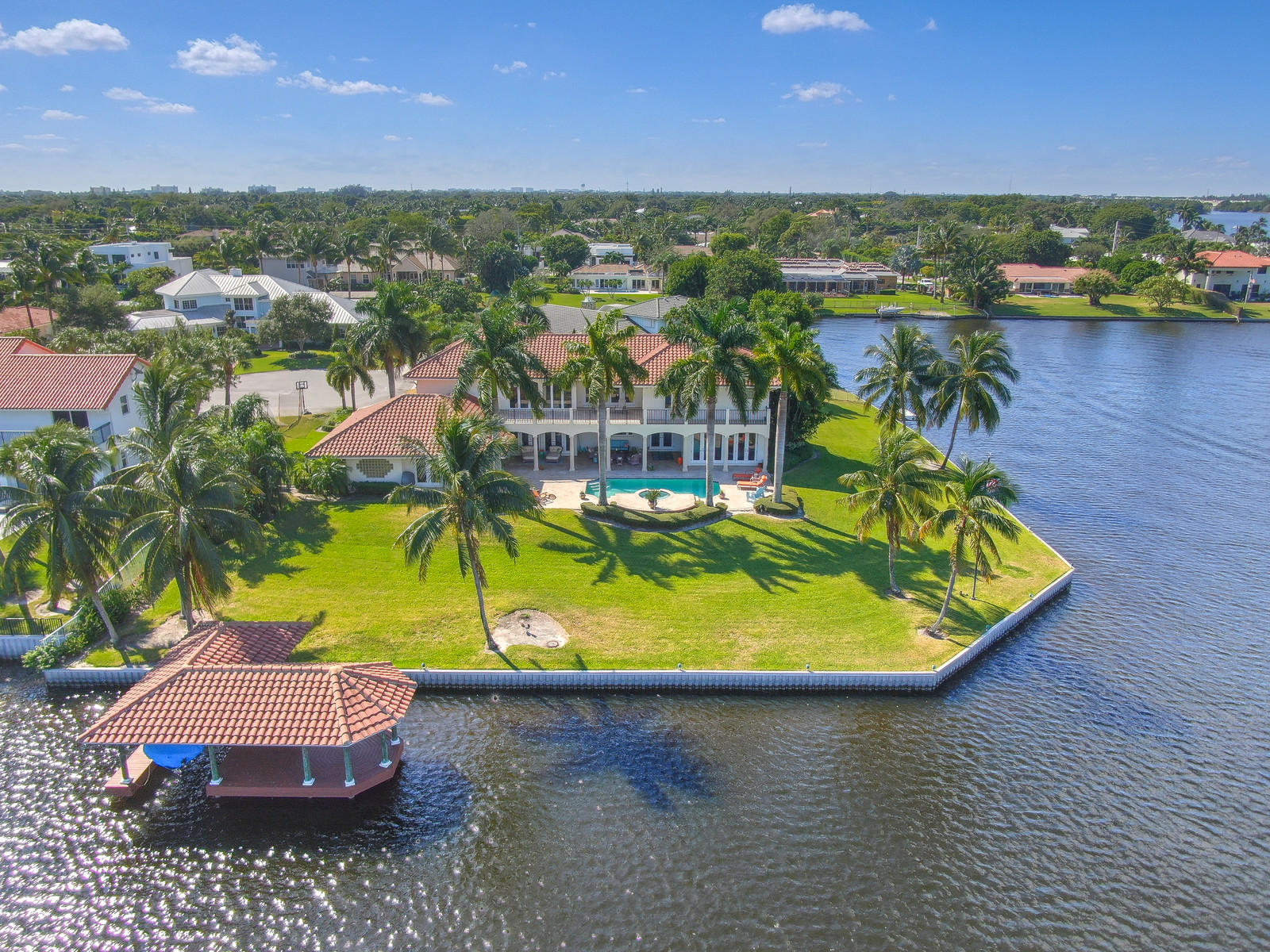 Expansive and secluded waterfront point lot located directly on Lake Eden in Delray Beach. This home boasts 325 feet of direct water frontage with open water views, a one-of-a-kind gazebo, and a boathouse with electric boat lift, heated pool, and hot tub spa. Large loggia with ample seating areas and dining areas, multiple outdoor balconies, and seating areas overlooking beautiful Lake Eden. This 6 bedroom, 5 full bath, 2 half bath, immaculate home has living/family rooms on two levels, a private office, an expansive master bedroom with panoramic open water views, and French doors leading to the water. Hurricane Impact glass and impact French doors are throughout the house. The spacious 3 1/2 car garage is ideal for car aficionados, with ample storage area for wave runners or water toys. Located at the end of a cul-de-sac and surrounded by water, this home is a water enthusiasts' paradise. Lake Eden offers boating, paddle boarding, fishing, kayaking, and of course, spectacular sunsets. Located close to public and private schools and just minutes from the beach, Delray Tennis Center, public and private golf courses, restaurants, and shopping in beautiful downtown Delray Beach.