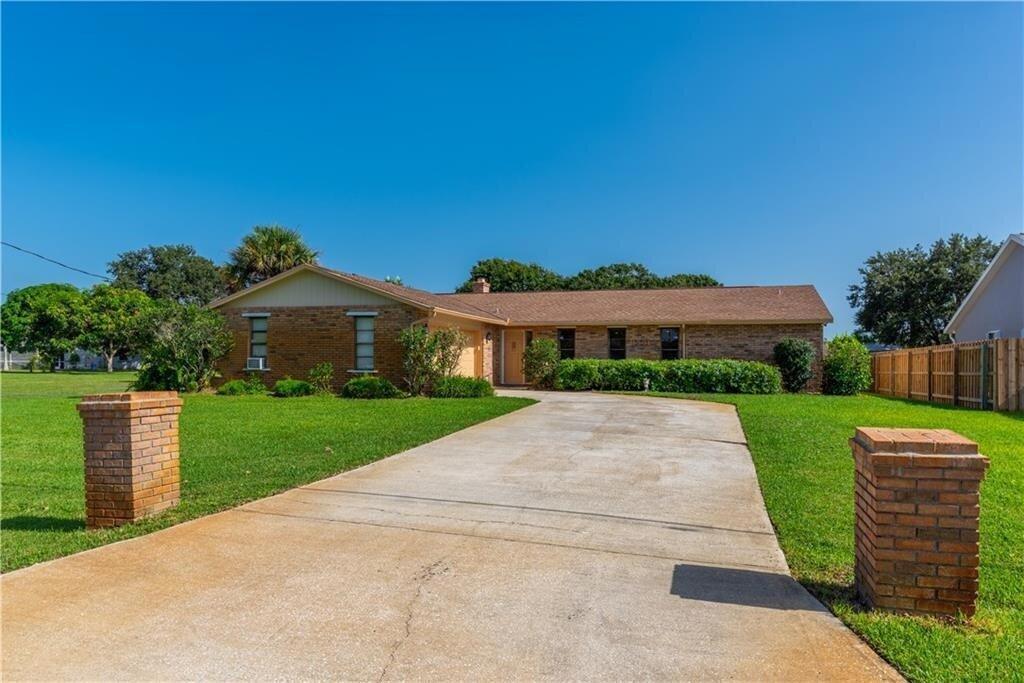 "WELCOME TO THE RESORT"     This well built Brick and CBS home has everything you need to enjoy life and entertain family and friends.  Large 3 Bedroom and 2 newly updated full baths.  Full laundry area, Brick fireplace and updated kitchen with Granite countertops.  Large family room with full sized pool table and entertainment area.  Separate office area for filing records and planning needs.  Custom window shades throughout.  Updated appliances in kitchen.       Offers a beautifully landscaped yard complete with its own well and sprinkler system.  Whole house water filtration system for drinking and bathing needs.  Wired home generator included as well as shutters for hurricane protection.     Custom built in-groun heated pool with a Full tiki bar for BBQ parties and sports viewing.   Two car garage for parking or storage needs.  Lovely 10 x 20 spacious art studio and full office with wired Wi-Fi, A/C and private entrance to enjoy crafts and solitude.       New roof installed in 2023 and pool heater in 2022.