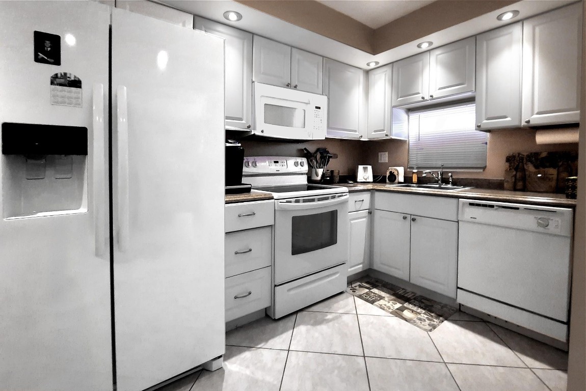 Nicely furnished, Move in ready,  upgraded 2nd floor apartment with beautiful golf and pond views. Tile floors throughout. Upgraded open kitchen with raised ceiling, high-hat lighting, and upgraded appliances and cabinets with granite counters. All furniture and accessories included if desired. Both bedrooms in rear facing the PGA rated golf course and pond.  Paid up rec lease. Free golf , 14 tennis courts, 7 pools, theater, fitness center, restaurant , 24 hr security,. Assoc. represents housing for older persons authorized (HOPA).. Buyer must be able and willing to sign FIRPTA exemption certificate.