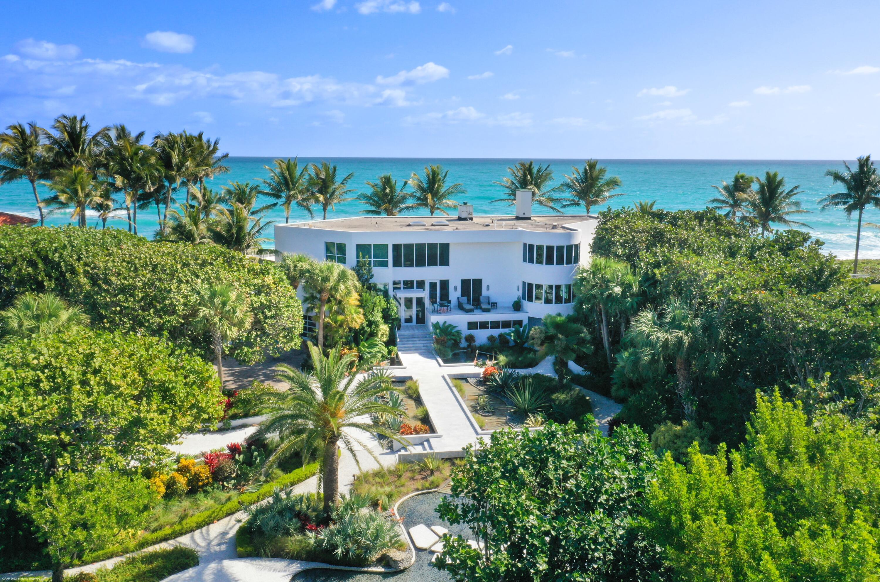 Welcome to ideal indoor-outdoor living, at its best. Live at the water's edge, with both 150' ocean & 150' intercoastal frontage! Nestled in between are private landscaped tropical gardens with specimen trees and rare plantings. 2 outdoor kitchens/grills further enhance the ultimate entertaining & relaxation experience. It is truly a rare find. This luxurious, bright, & unique 6200 square foot home with breathtaking views from every window, has 6 bedrooms, 4.5 bathrooms and a guest suite with private entrance. 3 car garage, private dock with 40,000 lb boat lift, whole house generator, and reverse osmosis water system for irrigation or just a few of the luxe amenities. Ideal for fabulous entertaining on the ocean, intercoastal, in your private garden, & of course, in this magnificent house!