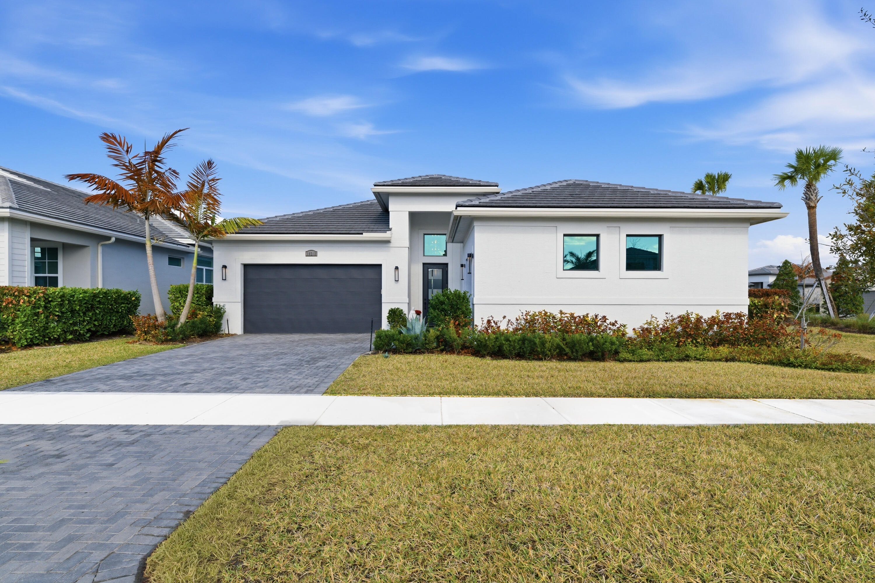 When lifestyle and luxury collide, you discover this exceptional corner residence in the most desirable area of Port St. Lucie. Featuring 4 Bedrooms, 4 1/2 Baths, this home offers the perfect blend of elegance, comfort, and prime location--just minutes from top dining, shopping, golf, and beaches. From the moment you enter, you're captivated by curated interiors with custom Restoration Hardware finishes throughout. Built with the Builder highest upgrade package, every detail has been elevated, including designer lighting and fixtures. Each spacious bedroom features a private en-suite bath, while the secluded owner's suite provides a serene retreat. The chef's kitchen with a grand island and walk-through pantry creates the ultimate space This community offers resort-style living with a modern clubhouse, EGYM fitness center, group classes, dining, and a poolside bar. Enjoy pickleball, tennis, basketball, and a full calendar of events. This vibrant community delivers luxury amenities, active living, and year-round recreation for all ages.