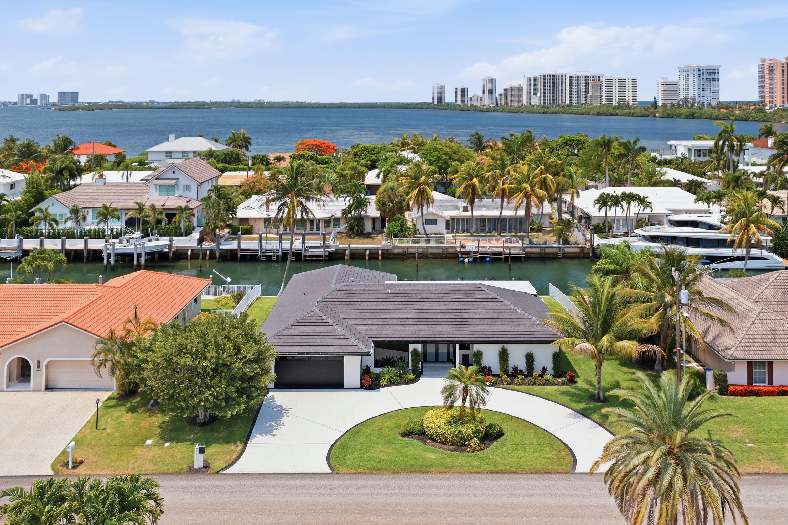 Welcome to this exceptional single-story residence in Palm Beach Isles, located on Singer Island with direct waterfront access. This 3,456 square-foot home features five spacious bedrooms and four full bathrooms, offering abundant room for comfortable living. The two-car garage provides convenient vehicle storage and protection. Situated on waterfront property, this residence presents a unique opportunity to enjoy coastal living with all the space and amenities a modern home demands. Discover the distinctive appeal of this waterfront single-family residence in this established Singer Island community.