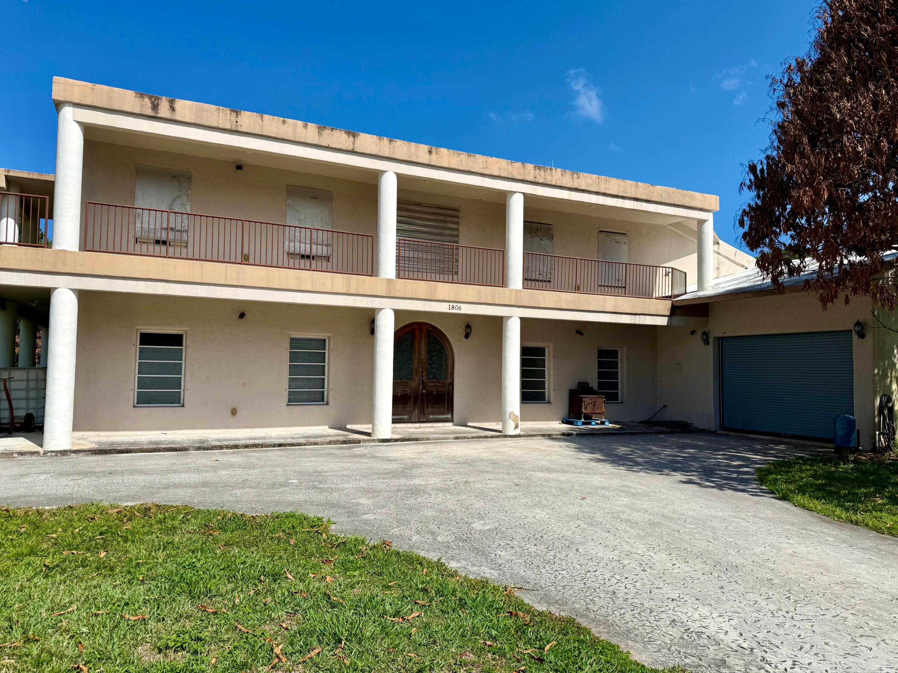 Some photos have been digitally altered to show rooms vacant. All Permanent structural element remain unchanged. Unique ICF (Insulated Concrete Form) construction featuring 5" insulation and 6" poured concrete walls, along with a concrete roof reinforced with rebar tied into the walls—built for durability and long-term performance. The property offers approximately 6,000 sq. ft. under roof (priced at $250 per sq. ft.), not including an additional 2,200 sq. ft. of wraparound porches spanning both levels. Zoned and city-compliant for a small retail business, the property includes two points of access and a separate private drive.  The current business generated over $450k in gross revenue in 2025, with projected growth exceeding $550k in 2026. A six-month training period is available for a smooth transition. The home is currently configured as a 3-bedroom, 3-bath layout with 3,600 sqft of living space 1,600 sq. ft. of workspace, and a 750 sq. ft. mother-in-law suite. The suite has a private entrance and can easily serve as a showroom or guest quarters. The flexible layout also lends itself to uses such as a halfway house, sober living facility, or assisted living setup. Fully handicap accessible, the property features 3-foot-wide doorways and a 4-foot-wide staircase. Conveniently located near shopping, major highways, schools, a trauma hospital, IRSC, and just 5 miles from the beach. Situated on an oversized corner lot comprising four parcels, the fenced yard includes mature fruit trees and offers ample space for gardening, recreation, pets, or future expansion.