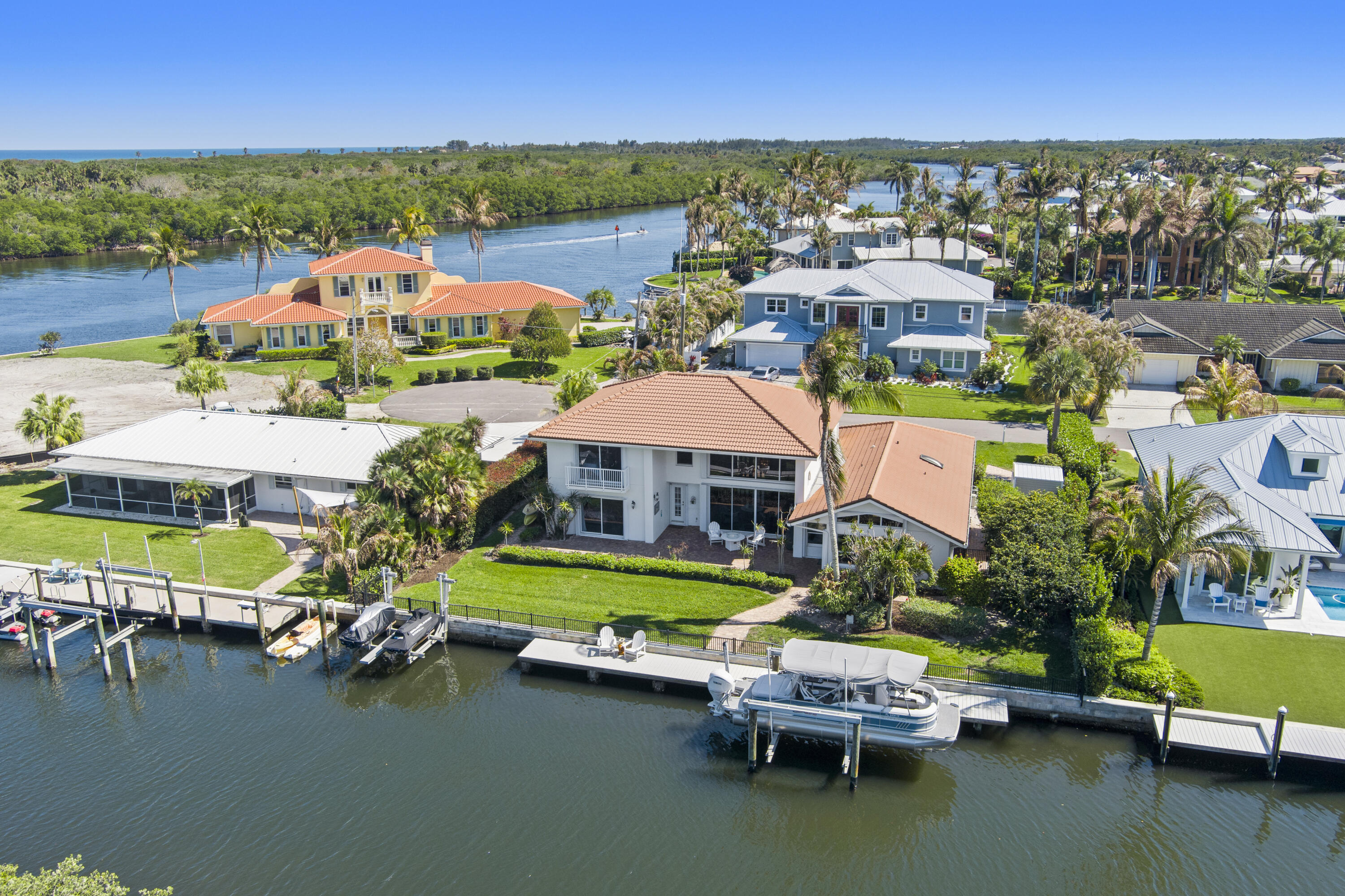 Most canal homes look straight across at another backyard. This one does not. Instead of maintaining a pool or completing home improvement projects, spend your weekends on the boat, at the beach, or relaxing by the water. The outdoor setting is designed around true waterfront living, with private dockage, open lawn space, and a rare sense of privacy along the canal. This remodeled CBS home offers approximately 100 feet of waterfront, open canal views, 4 bedrooms, 3 baths, soaring ceilings, a first-floor primary suite, concrete seawall, dock, boat lift, and jet ski davits, minutes from beaches, dining, golf, Jupiter, and Stuart.