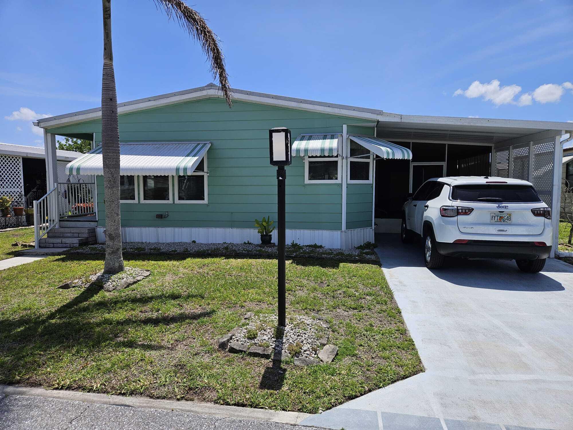 Make your ''Florida Dream'' come true in this beautiful home. 55+community-NO LAND LEASE! Motivated seller! This 2/2 features an L-shaped kitchen w/light wood cabinets, countertop stove and convenient wall oven. Enjoy morning coffee in your cheerful breakfast room. Both baths tastefully remodeled w/newer vanities, showers and commodes. New hot water heater installed 2024. Laminate flooring throughout. Metal roof, newer windows w/clam shell awnings. Low monthly maintenance includes cable TV, Hi Speed Internet, Clubhouse with amenities, trash pick up and common ground maintenance. You pay water, electric and lawn care. RV/boat storage available. Near shopping, restaurants and beaches. Ride your bike to St Lucie River!