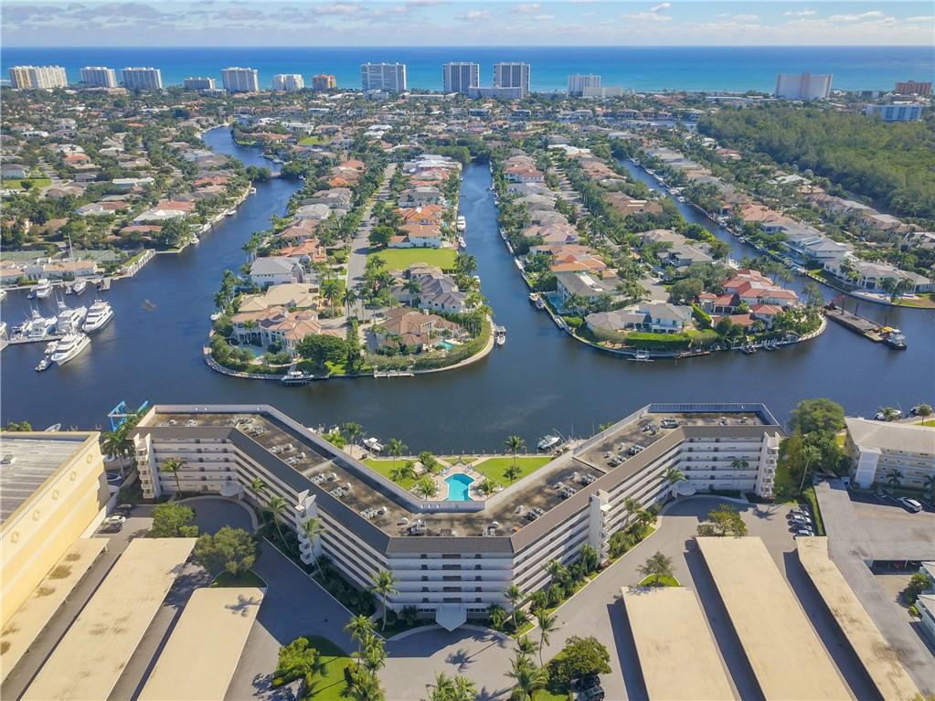 As soon as you enter the unit, the unobstructed water view will entice you to the balcony to see water in every direction, a pool below you and multi-million-dollar homes across the canal in the Royal Palm Yacht and Country Club. This unit has been totally updated, including hurricane windows and front door. 40-year inspection has been done, the roof is currently being replaced, all other repairs have been completed and seller has paid the special assessment in full. Documentation available upon request. Boat dockage rents for $80 for 23' boat & $120 mo for 35' boat when available.  One assigned covered carport for your car and ample guest parking for 2nd car. Laundry room and bicycle room are 1 & 2 doors away.