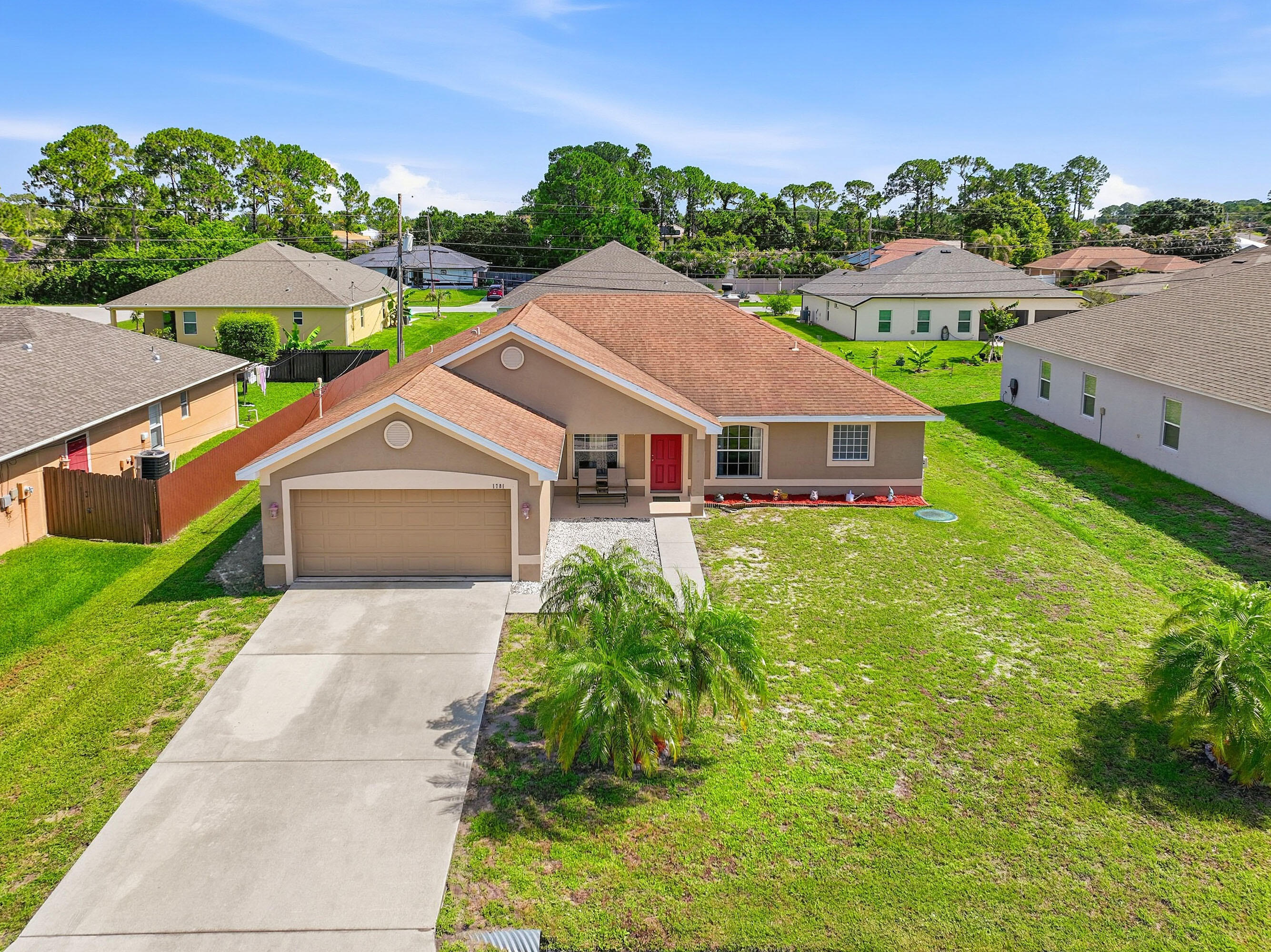 Don't miss this well-maintained 3-bedroom, 2-bath, 2-car garage home with a Den that can easily be converted to a 4th bedroom in a beautiful Port St. Lucie location! The open floor plan features vaulted ceilings, tile flooring throughout and a cozy wood-burning fireplace that adds warmth and character. Enjoy relaxing or entertaining on the covered patio overlooking the backyard. Conveniently located near shopping, dining, parks, schools and major roadways, this home offers comfort, convenience and value. A wonderful opportunity to enjoy the Florida lifestyle!
