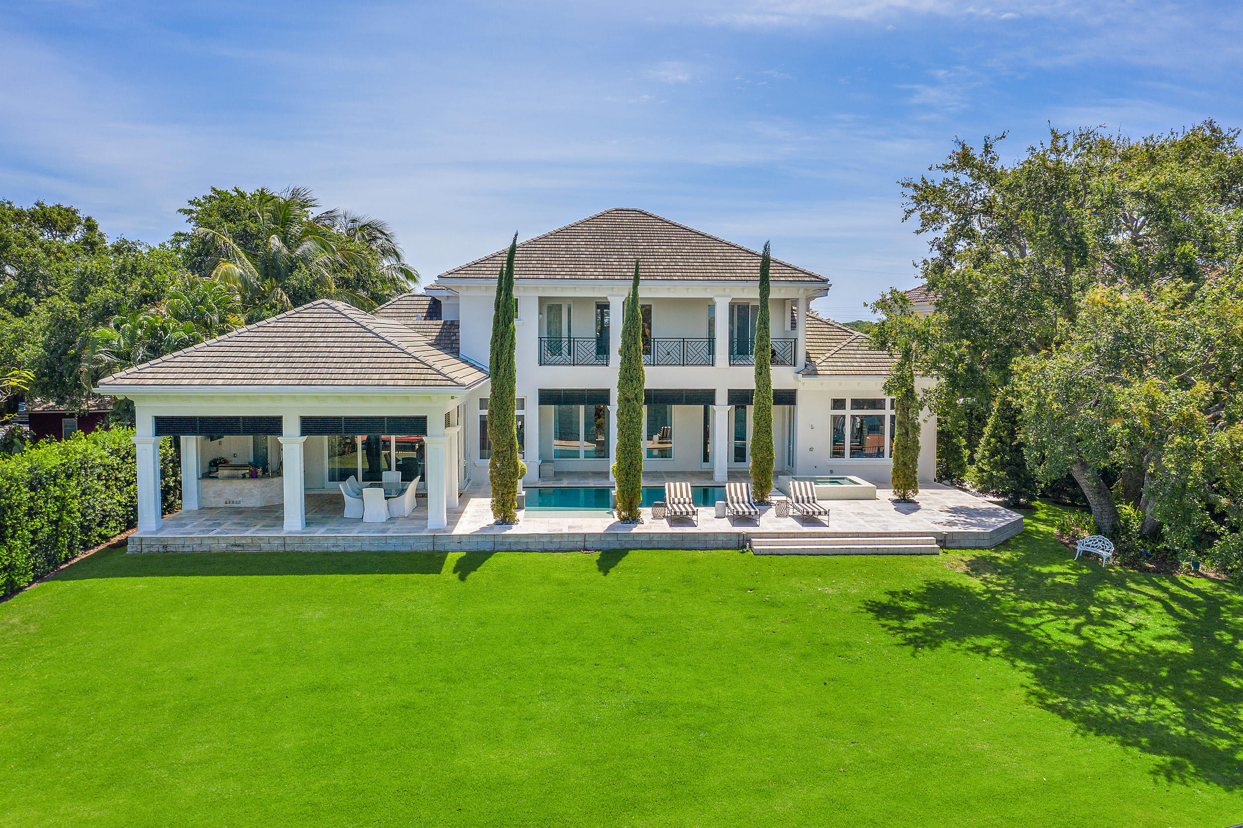 With just over a half acre and 132' of Intracoastal frontage this home has a large backyard and commanding views of the ICW. The home offers 5 bedrooms with all en-suite bathrooms, a first floor master bedroom with His and Her closets, a breakfast bar, an office, 2nd floor loft, exercise room and large covered lanai with summer kitchen. The Chef's kitchen offers a gas cooktop, spacious countertops, two sinks and a wine cooler. Other amenities include a 4 car garage with workshop area, a 48 KW whole house generator and a dock with 20,000lb lift.