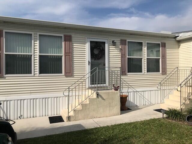 Beautiful well maintained 3 bedroom 2 bath manufactured home in Spanish Lakes Community with lake views. Custom Palm Harbor Model built in 2005 located at the end of a cul-de-sac. Home is 1,853 sqft of living with a den that could be a fourth bedroom with a separate entrance. Home features include drywall finish with extra insulation between walls and floor. Wood laminate floors in the family room, dining room and den. Title in kitchen and bathrooms. Island in kitchen with corian sink. Master suite has separate shower and jacuzzi tub. Family room has a wood burning fireplace. All stainless steel appliances and upgraded Cherry cabinets. Laundry room inside with large pantry. Brand new water heater, Brand New A/C unit and Home has 6 solar tubes for nature light throughout the home. Home comes partially furnished and a must see. Land Lease, buyer must be approved by the HOA to purchase. Home is in the pet section.