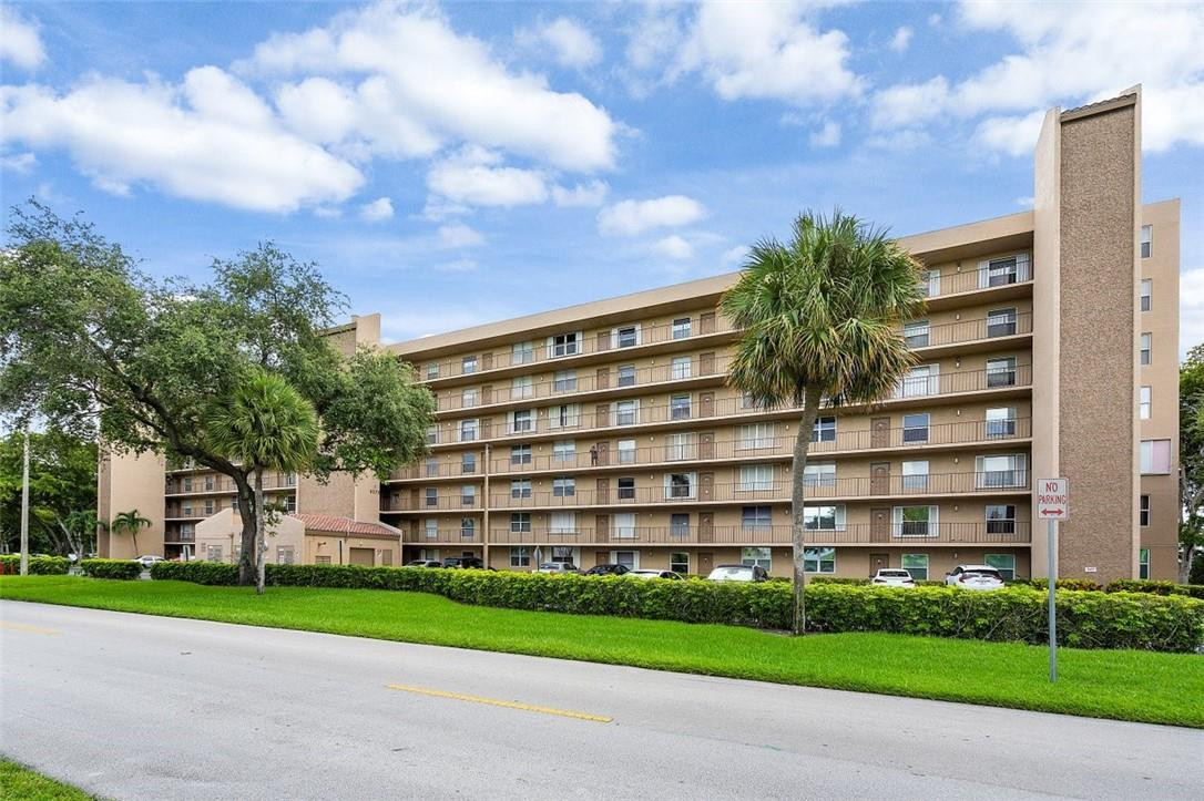 Exquisitely & fully renovated CORNER UNIT!  This 2/2 condo is stunning and the photos speak for themselves. Open Floorplan with exceptional amount of light and screened in patio to make a cozy outdoor living space. Large master bath with two sinks, quartz counter top and wood flooring in this this ALL AGES Condo. The association requires min 700 score. Pet & rental restrictions. Heated pool, hot tub, BBQ area, tot lot, exercise room, game room, library, clubhouse, shuffleboard, additional storage on the floor, 1 assigned parking spot. Plenty of additional guest parking. Close to I-95 & Turnpike. Service Pets are welcomed! Unit comes with a storage unit on the same floor. Washer and Dryer excluded