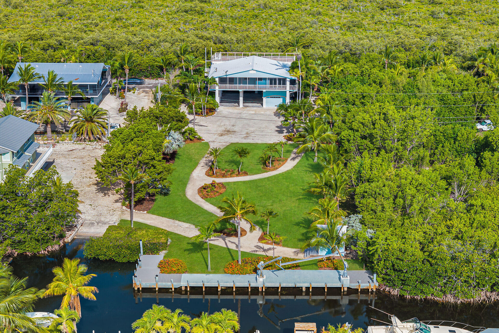 Welcome to Paradise! this home sits on almost 3/4 of an acre along a direct access canal with 100 ft of waterfront, a turning basin and neighborhood only boat ramp with no HOA! Want to park your RV and Boat under your home, done! Want to build your own luxury oasis, here you go. Want to just enjoy easy access to open water and majestic Sunsets from your private observation deck, got that covered! Fully screened wrap around porches allow you to open up and let the East - West trade winds breeze right through the entire home. Professionally landscaped perfection from your private dock with davits, boathouse and garden paths to the exterior elevator and massive shop/storage area downstairs. Close to Adams Cut for easy oceanside access. 1 hour from Miami international airport yet in the other.