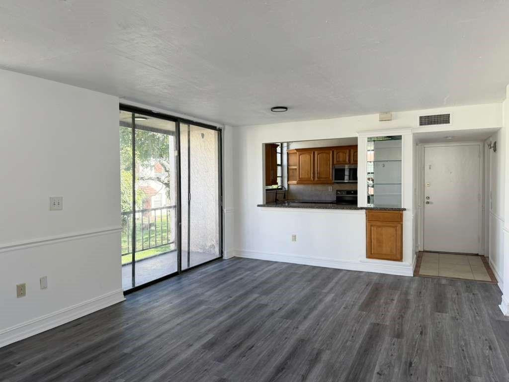 Turnkey Key Ready! Large two-story 3 bed/2.5 bath condo townhouse located on the second floor of a 3-story building in an all-age gated community. Nice and bright unit with updated appliances and bathrooms. The kitchen is opened up to a large living room area and dining room area. There is vinyl flooring throughout and a laundry/utility room with a full-size washer/dryer. Water, sewer and all insurance is included too!! PETS ARE NOT ALLOWED. NO RENTALS RESTRICTIONS! It can be rented the first day you own! Great Investment opportunity !! Also we have other unit available already rented at 2