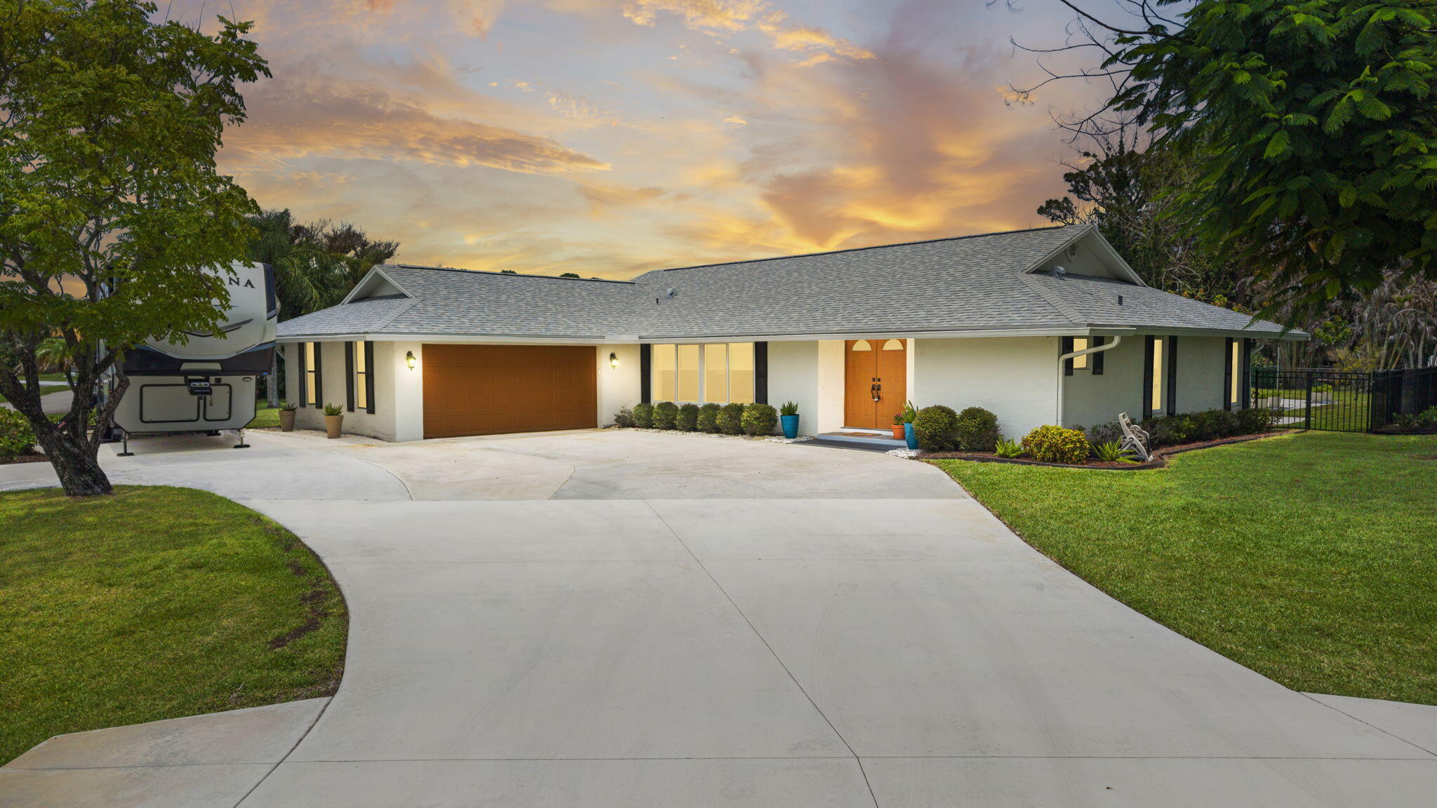 This meticulously maintained CBS, 4 BR, 3 BTH, 2 CG  salt water pool home sits on a .63 acre lot, it is fenced and beautifully landscaped with mature fruit trees and a lush lawn; and it boasts two master suites. The open concept kitchen has been thoughtfully upgraded to include Stainless Steel appliances, granite countertops and a skylight with an electric retractable shade. The home offers impact windows except on the bathrooms and the sliding doors, and the warranty is transferable. ROOF 2022, A/C 2024, WATER HEATER 2025 and the POOL/FENCE (2013) was recently resurfaced. Out back, the pool and sun deck are surrounded by tasteful potted greenery and ample lounging space. The security cameras will not stay and the Ring door bell will be replaced. Measurements are approximate.