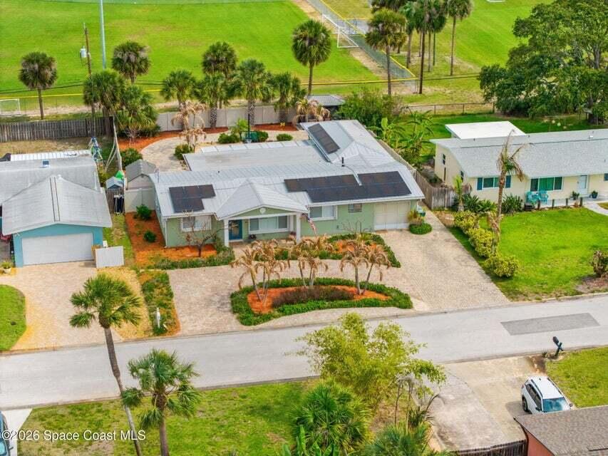 Tucked into the heart of sought-after Indian Harbour Beach, this versatile 4BR/3BA pool home offers the perfect blend of coastal living, accessibility, and investment potential. Featuring two private suites, wide doorways, and a handicap-accessible bathroom, the flexible layout is ideal for multigenerational living, guests, or rental income. Multiple living areas and a spacious kitchen create a warm, inviting flow filled with natural light. Outside, enjoy a resort-style backyard with a fully pavered patio, covered seating area, pergola, pool, and extra storage. Metal roof and fully paid-off solar panels add efficiency and long-term value. Circular driveway, no HOA, beach proximity, and direct access to Algonquin Sports Complex complete this exceptional property.