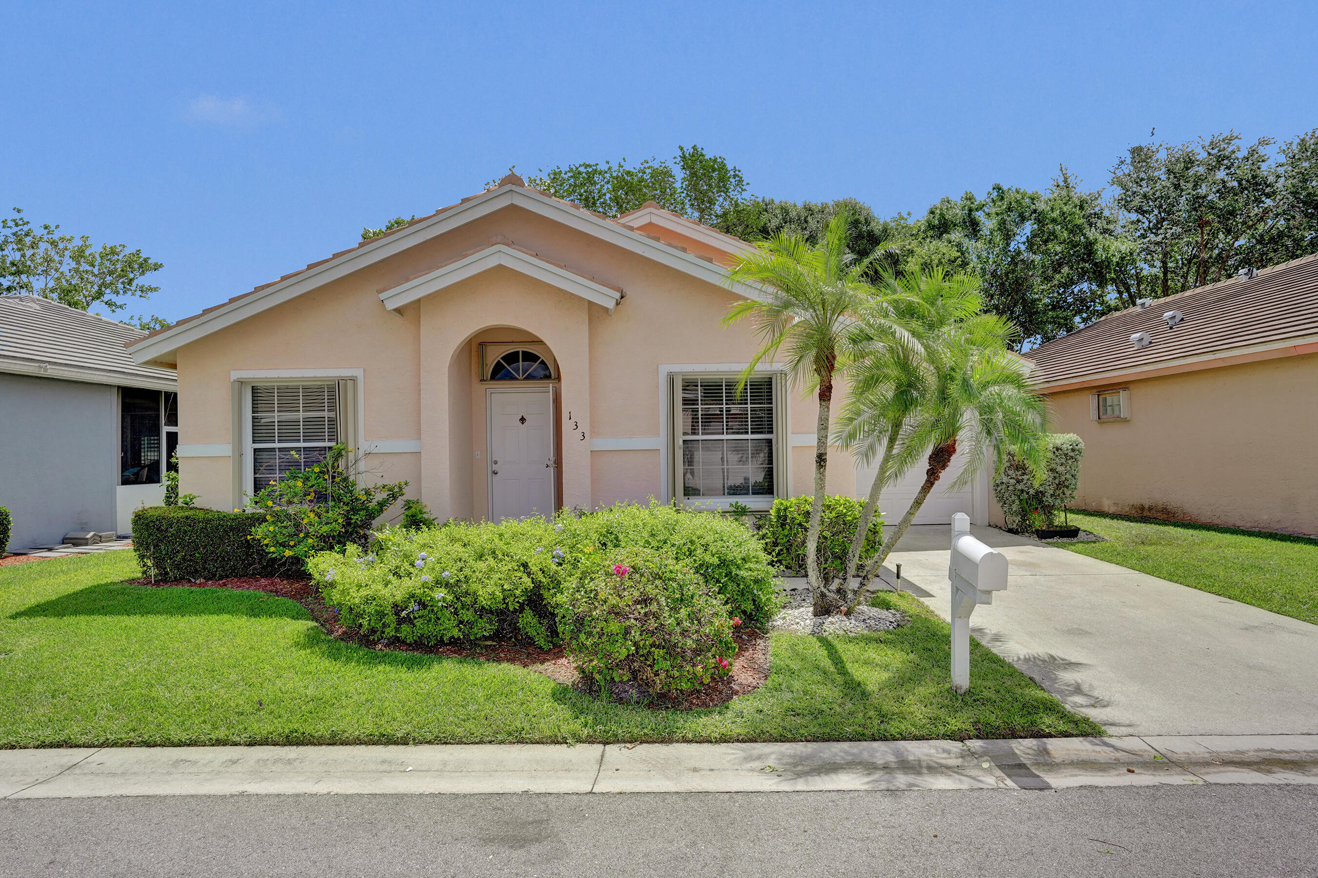 Welcome to your beautifully renovated retreat in the highly sought-after gated community of River Bridge! This move-in-ready 3-bedroom, 2-bath residence offers the perfect blend of modern style, comfort, and low-maintenance South Florida living. From the moment you arrive, you'll appreciate the charming curb appeal, manicured landscaping, and inviting entryway that set the tone for what awaits inside. Step into a bright and airy open-concept layout highlighted by soaring vaulted ceilings, abundant natural light, and elegant contemporary finishes throughout. The spacious living and dining areas seamlessly flow together, creating the ideal setting for both everyday living and entertaining guests. The completely renovated kitchen is a true showpiece, featuring sleek modern cabinetry, updated  countertops, brand new stainless steel appliances, and ample prep and storage space designed to inspire any home chef. The thoughtfully designed split-bedroom floor plan provides privacy and functionality. The generous primary suite offers vaulted ceilings, a large walk-in closet, and a beautifully updated ensuite bathroom with stylish designer touches. Two additional bedrooms and a renovated guest bath provide comfortable accommodations for guests, or a home office setup.  Enjoy peace of mind with a brand-new 2024 roof and full accordion hurricane shutters, combining convenience, safety, and potential insurance savings. Additional highlights include tile and luxury waterproof vinyl flooring, interior laundry, updated fixtures, and an attached garage.  Relax outdoors on the private covered porch and enjoy the serene surroundings of this beautifully maintained community.  The monthly HOA fee includes Cable TV, High Speed Internet and Lawn Maintenance as well. River Bridge offers resort-style amenities including multiple pools, spa/hot tub, tennis and pickleball courts, fitness and recreation facilities, playgrounds, walking paths, and 24-hour manned gated security. Conveniently located near shopping, dining, parks, major highways, beaches, and Palm Beach International Airport, this home truly delivers the best of Florida living.  Don't miss this exceptional opportunity to own a fully updated home in one of Greenacres' most desirable gated communities!