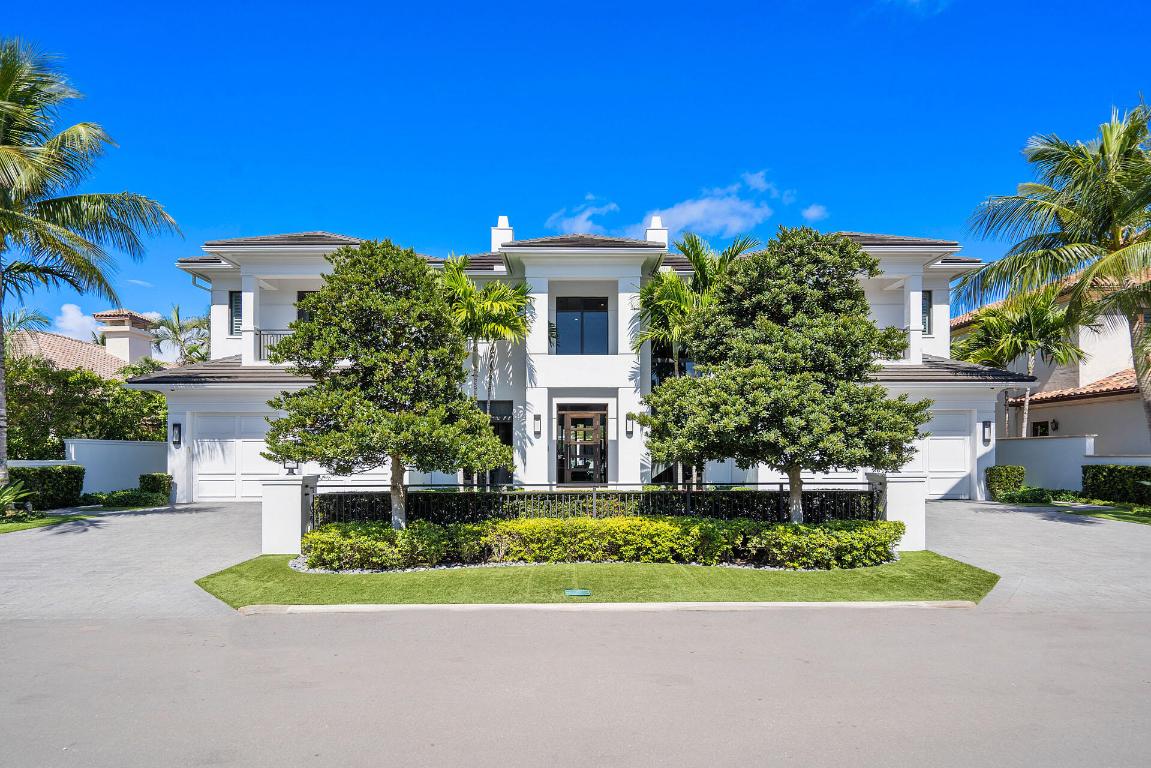 Sitting on 100' of the Buccaneer Palm Waterway within the prestigious Royal Palm Yacht & Country Club, 505 E Alexander Palm Road delights with panoramic waterfront views and first-class amenities. Over 7,400 sf of interior living offers 5 bedroom suites, club room with a bar, library, formal dining space, open-air chef's kitchen, and loft living room. The master bedroom is a tranquil retreat with a luxurious ensuite and glass sliding doors opening to a fantastic balcony spanning the length of the home. The resort-grade backyard offers exceptional luxuries, including a heated swimming pool/spa, a sizable summer room with an outdoor kitchen, and a private dock for the boating enthusiast! Designer furnishings by P&H Interiors included.