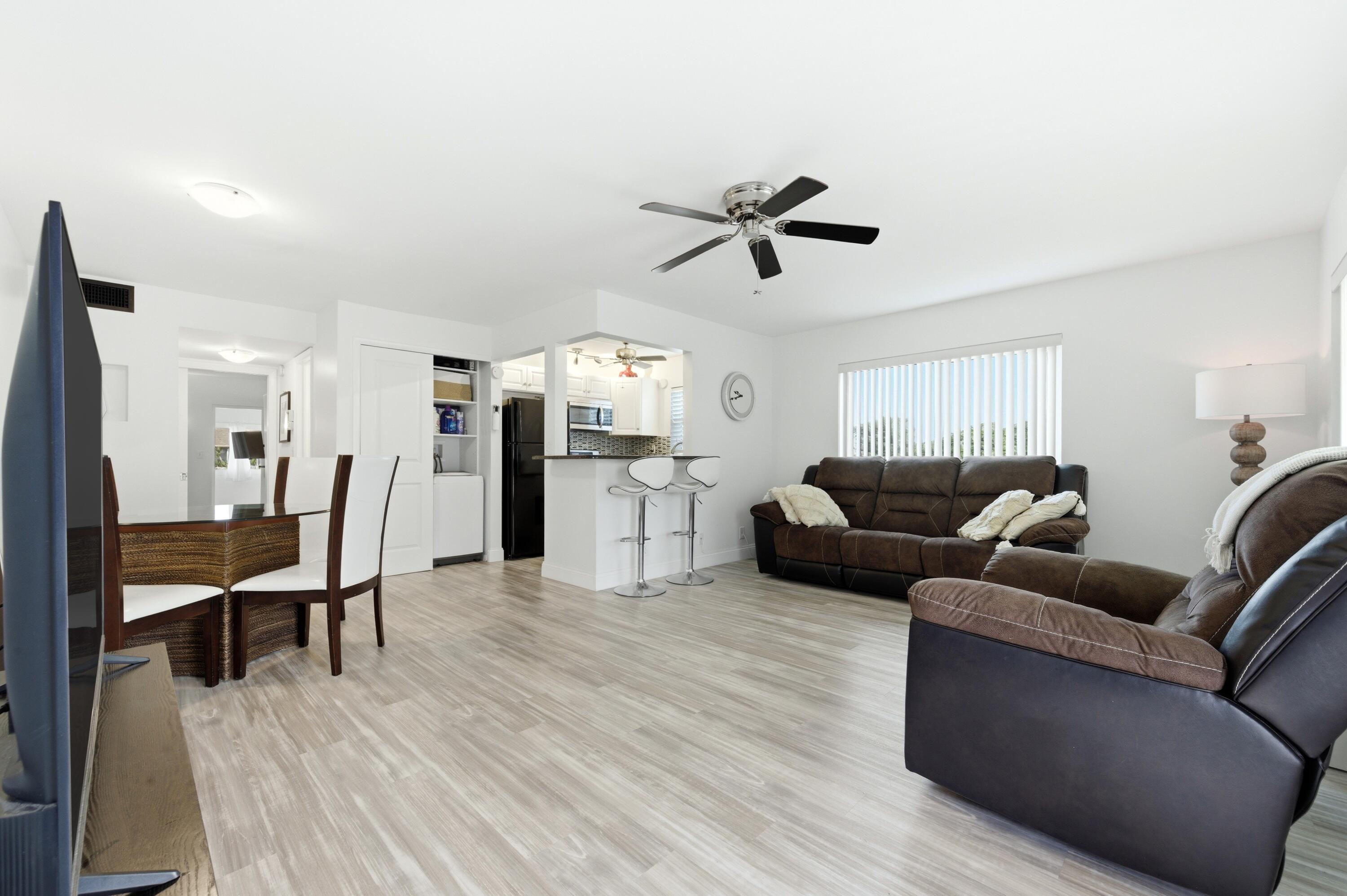 Beautifully updated and move-in ready end-unit offering added privacy and natural light in the sought-after Century Village community. This functional 2-bedroom layout features brand new vinyl flooring throughout, complete hurricane impact protection, newer appliances, popcorn removed in living area, new window treatments, and the convenience of a new in-unit washer and dryer. Additional highlights include attic storage space, a newly installed building elevator, and a recent roof replacement completed in 2024. Furnishings are available and negotiable, creating a seamless opportunity for seasonal or full-time living.  Enjoy the renowned Century Village lifestyle with access to exceptional resort-style amenities including a massive clubhouse, fitness center, indoor and outdoor pools, tennis and pickleball courts, billiards, theater, library, hobby rooms, courtesy transportation, and endless social activities. Ideally located in the heart of West Palm Beach just minutes from shopping, dining, Palm Beach International Airport, Florida's Turnpike, I-95, downtown West Palm Beach, and South Florida's beautiful beaches.