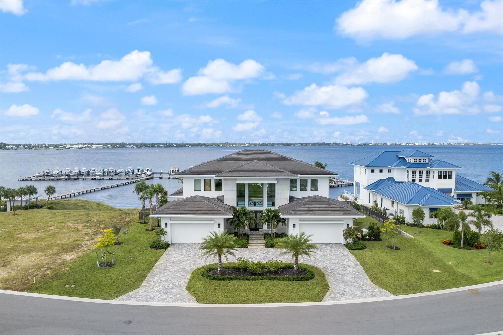Spectacular riverfront views from this home on .71 acre lot with 50' boat slip & 20Klb lift. Under air living of 5,125sqft, 4 bedrooms, 4.5 baths, large loft and flex space with 4 car garage with a total living space of 7,545sqft. Transitional style design with large outdoor living area complete with 2 sided fireplace, negative edge salt heated pool with sun shelf and spa with LED Lighting, and remote control. Entertain from the summer kitchen with 38'' grill, sink and outdoor beverage refrigerator. 3 electric Phantom screens on back patio for increased comfort. Large open plan featuring gourmet kitchen with double islands and service pantry and elevator access to 2nd floor.  Langford Landing is an intimate gated community of 48 home sites and 6 custom waterfront lots.