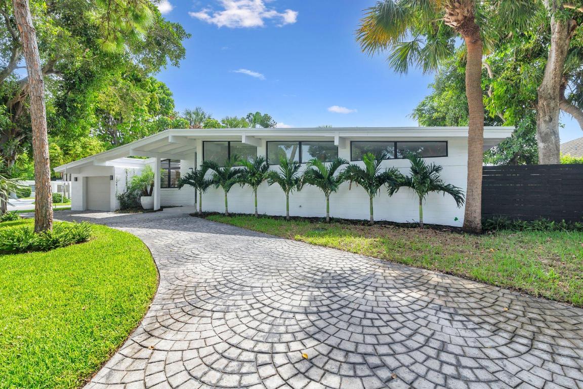 Mid-century modern architecture at its best! After a total renovation, this four-bedroom, three-bath home maintains all the classic elements of its original design. Generous-sized windows and soaring ceilings allow natural light to permeate throughout. The large entry foyer separates the bedroom wing from the open flow of the family gathering spaces. The extensive renovation encompasses all new hurricane-impact windows, new roof, new electrical system, two new HVAC units, new plumbing, and an air-conditioned garage. The original terrazzo floors have been meticulously restored, and the kitchen, laundry room, and baths have been completely reimagined. With its oversized pool and patio, the back yard is perfect for entertaining, and a well-shaded side yard is perfect for relaxing. The lush Florida landscaping and fencing provide full privacy and blend the lines between indoor and outdoor living. Close to Lake Clark Shores, the LCS town hall, tennis courts, pickleball courts, and children's playground.